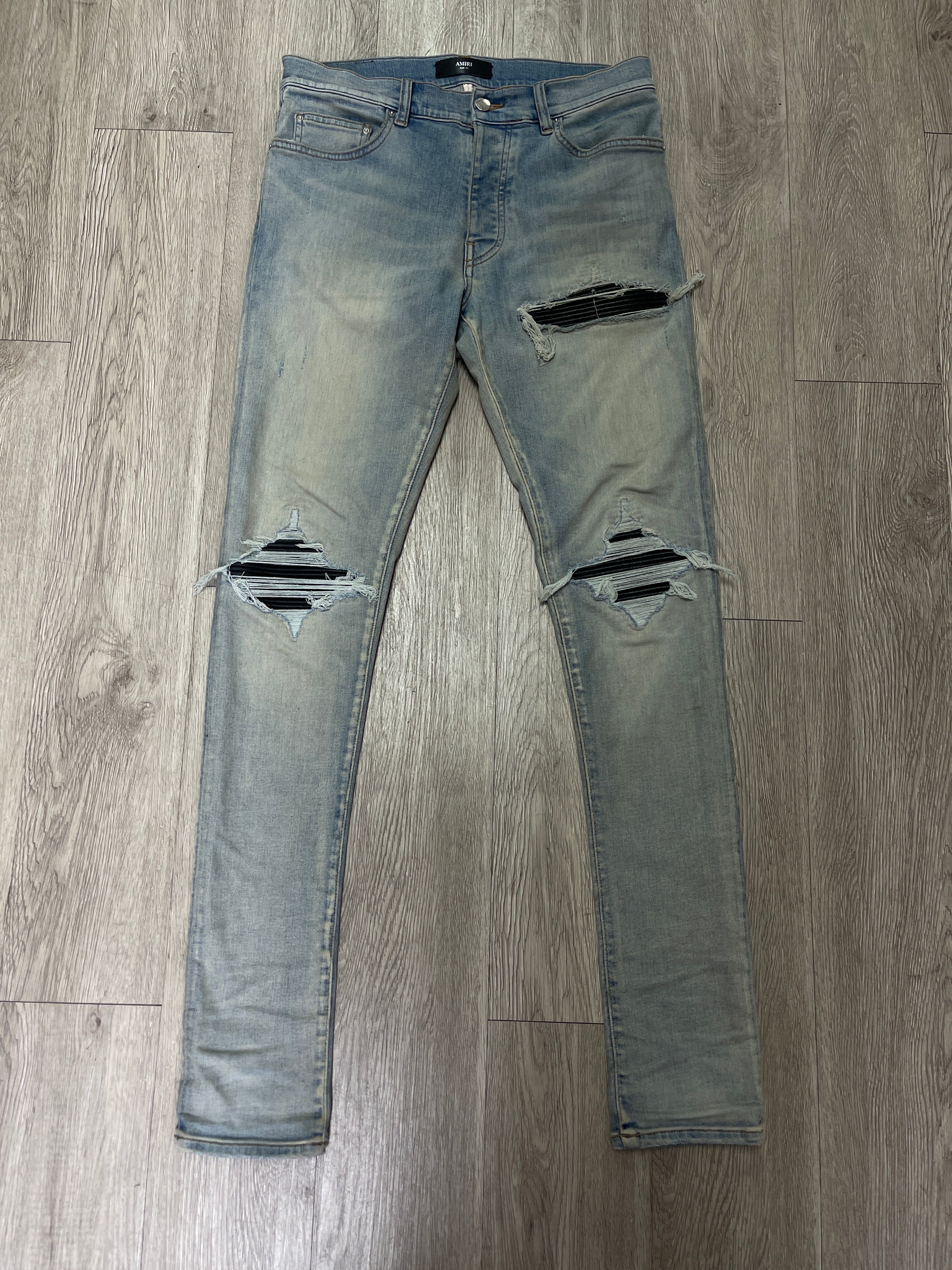 Amiri MX1 Light Wash Black Leather Patch Jeans