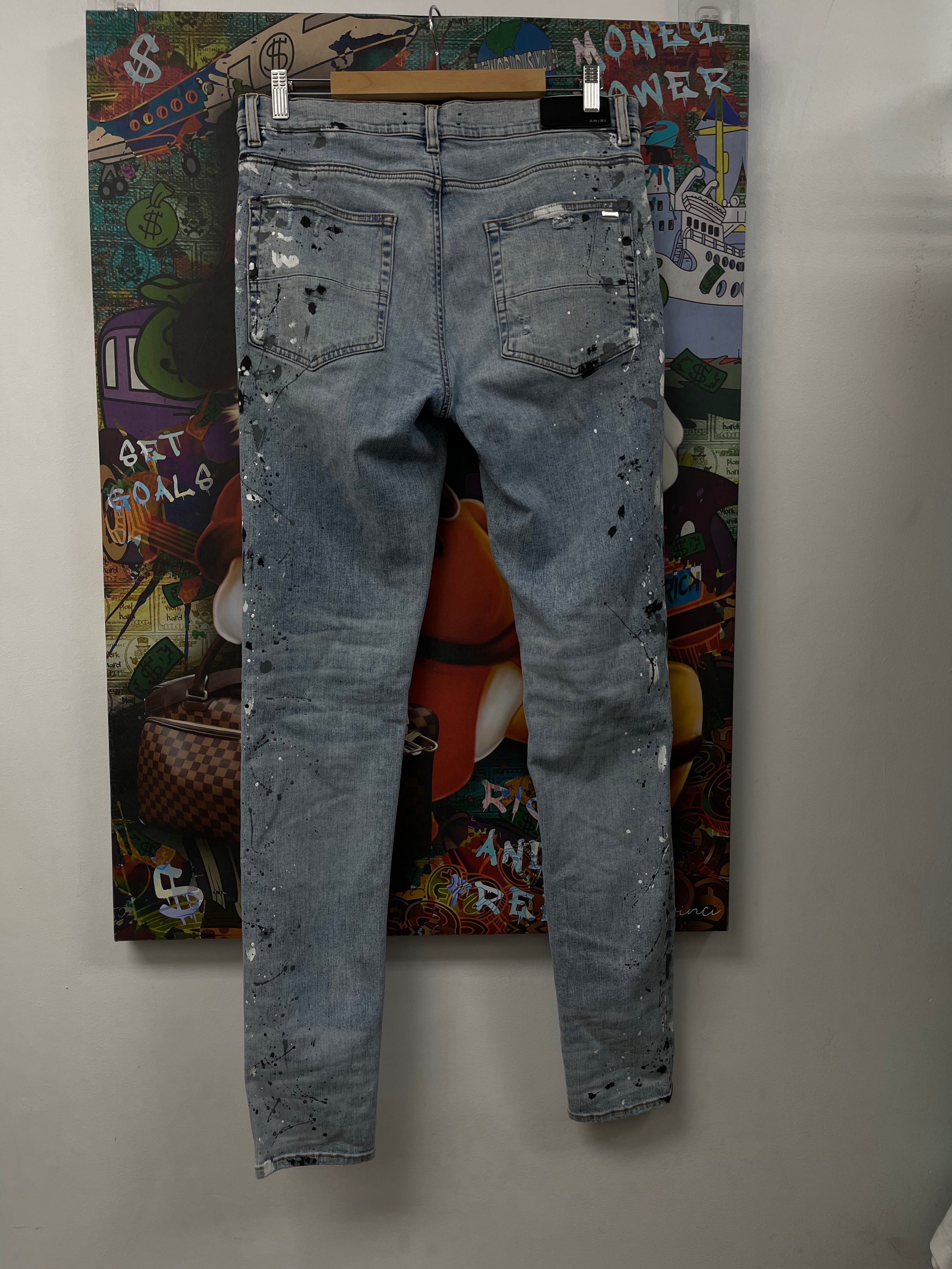 Amiri MX1 Light Wash Denim Splatter Patch Jeans