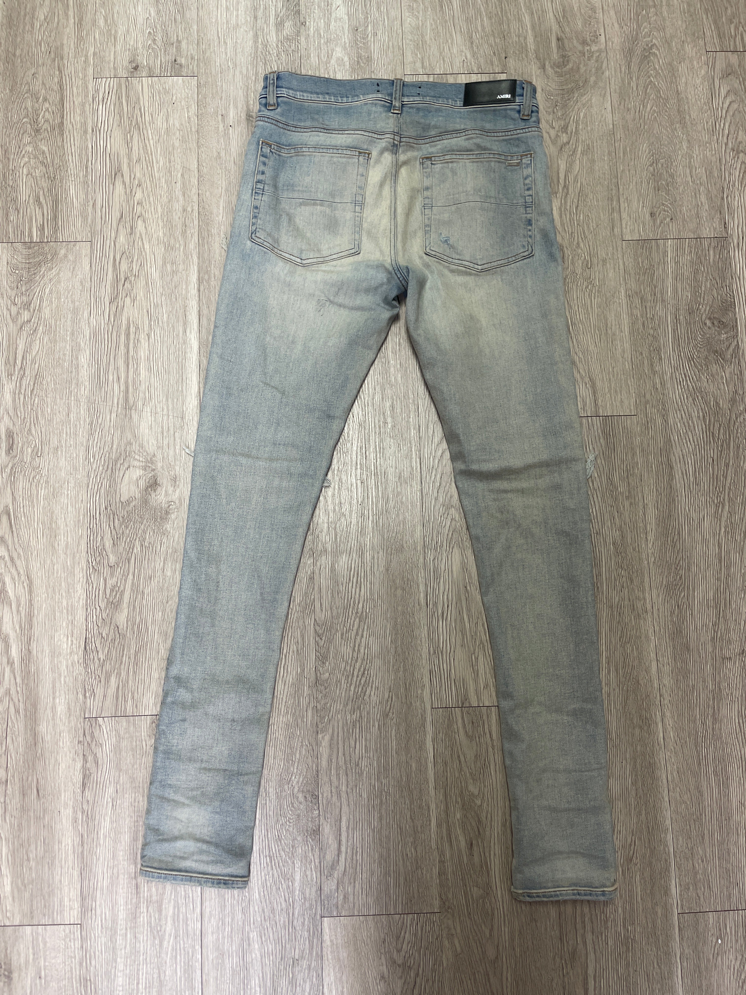 Amiri MX1 Light Wash Black Leather Patch Jeans