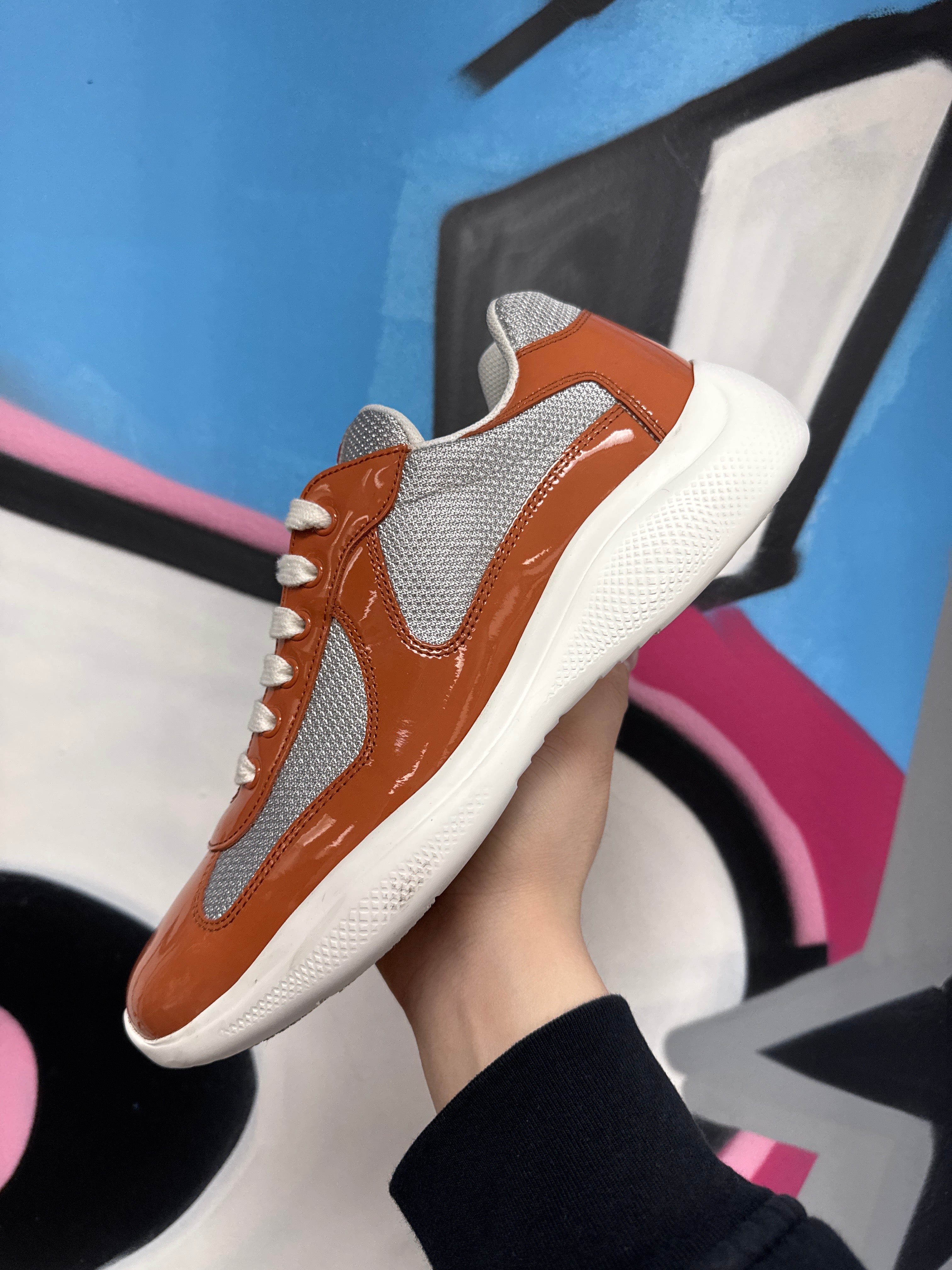 Prada Burnt Orange Patent Cup Sneakers