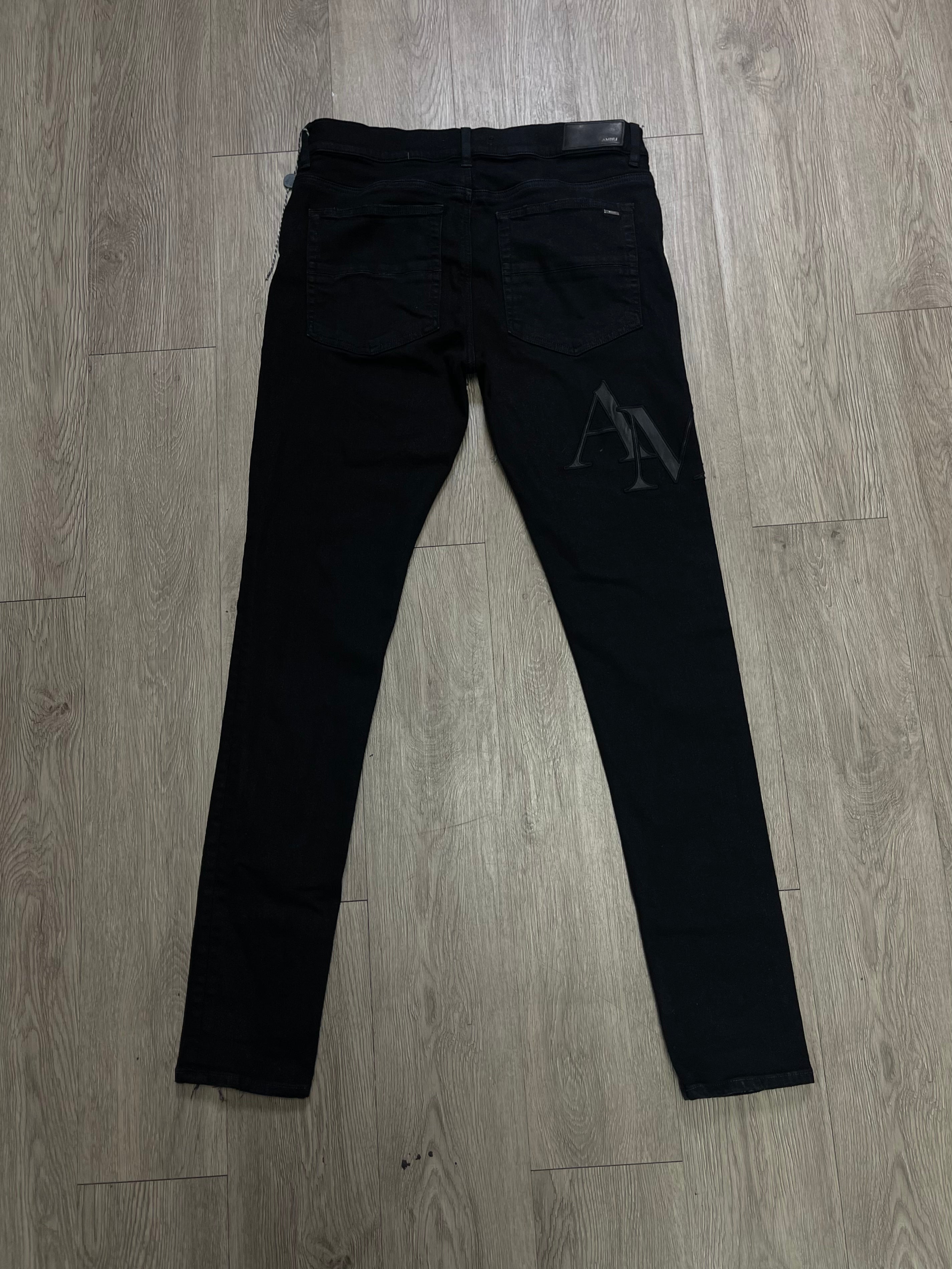 Amiri Black Wax Staggered Side Logo Jeans
