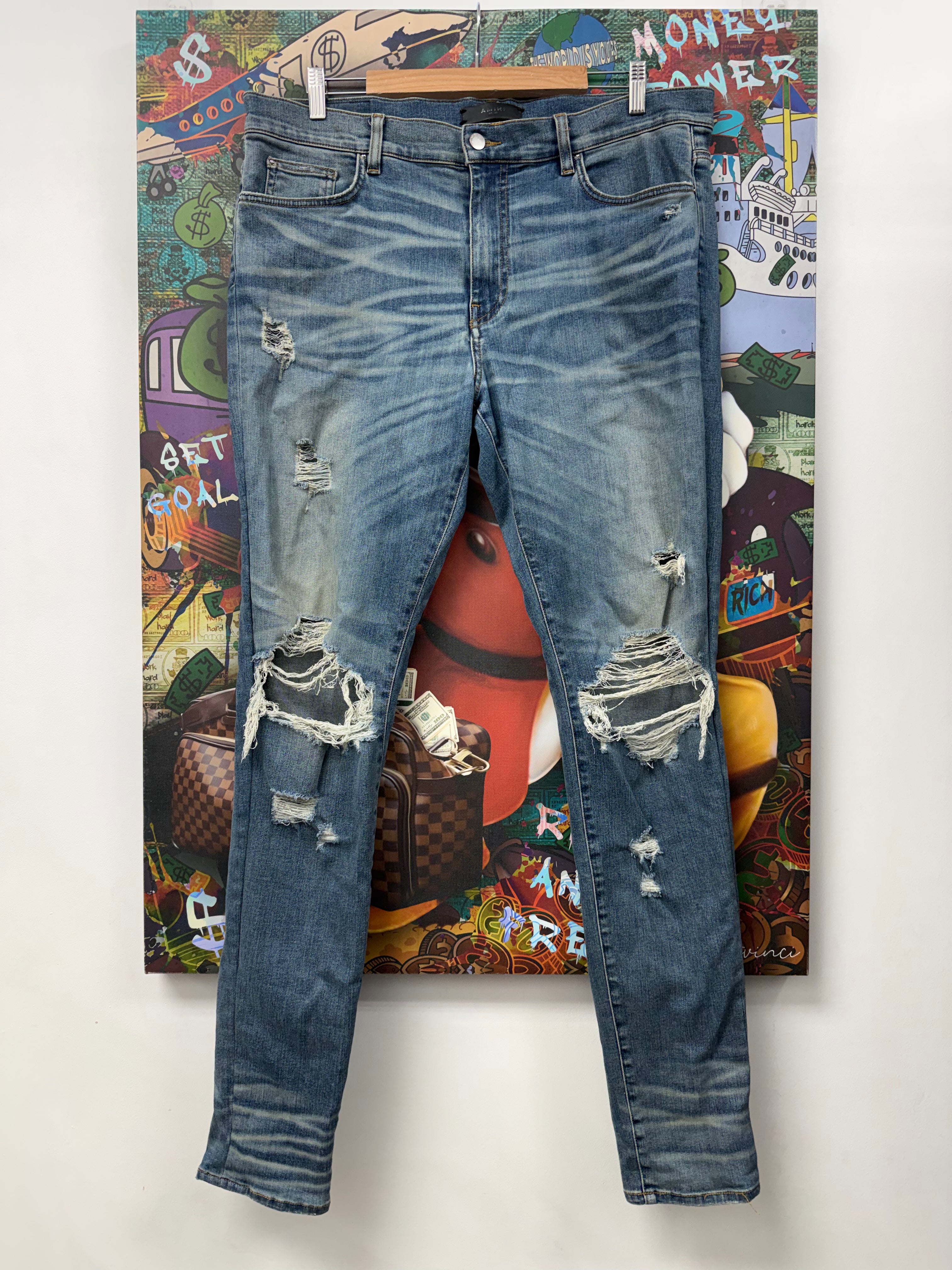 Amiri Light Wash Ripped Thrasher Jeans