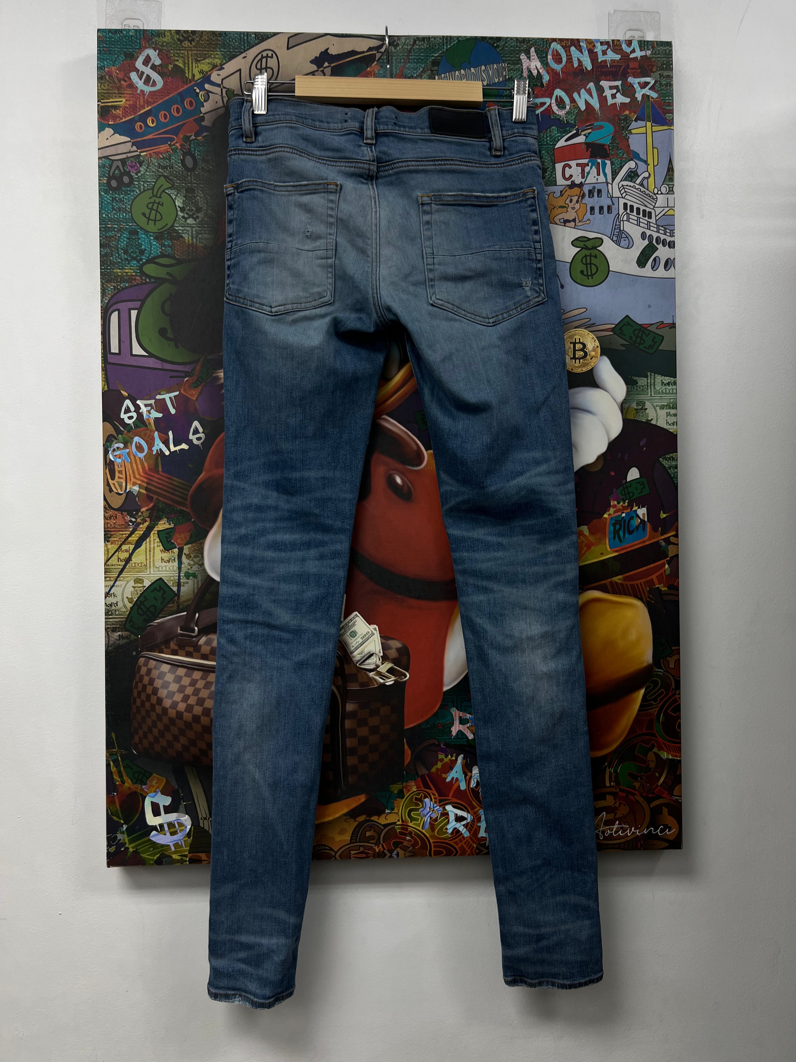 Amiri MX1 Light Wash Black Patch Jeans