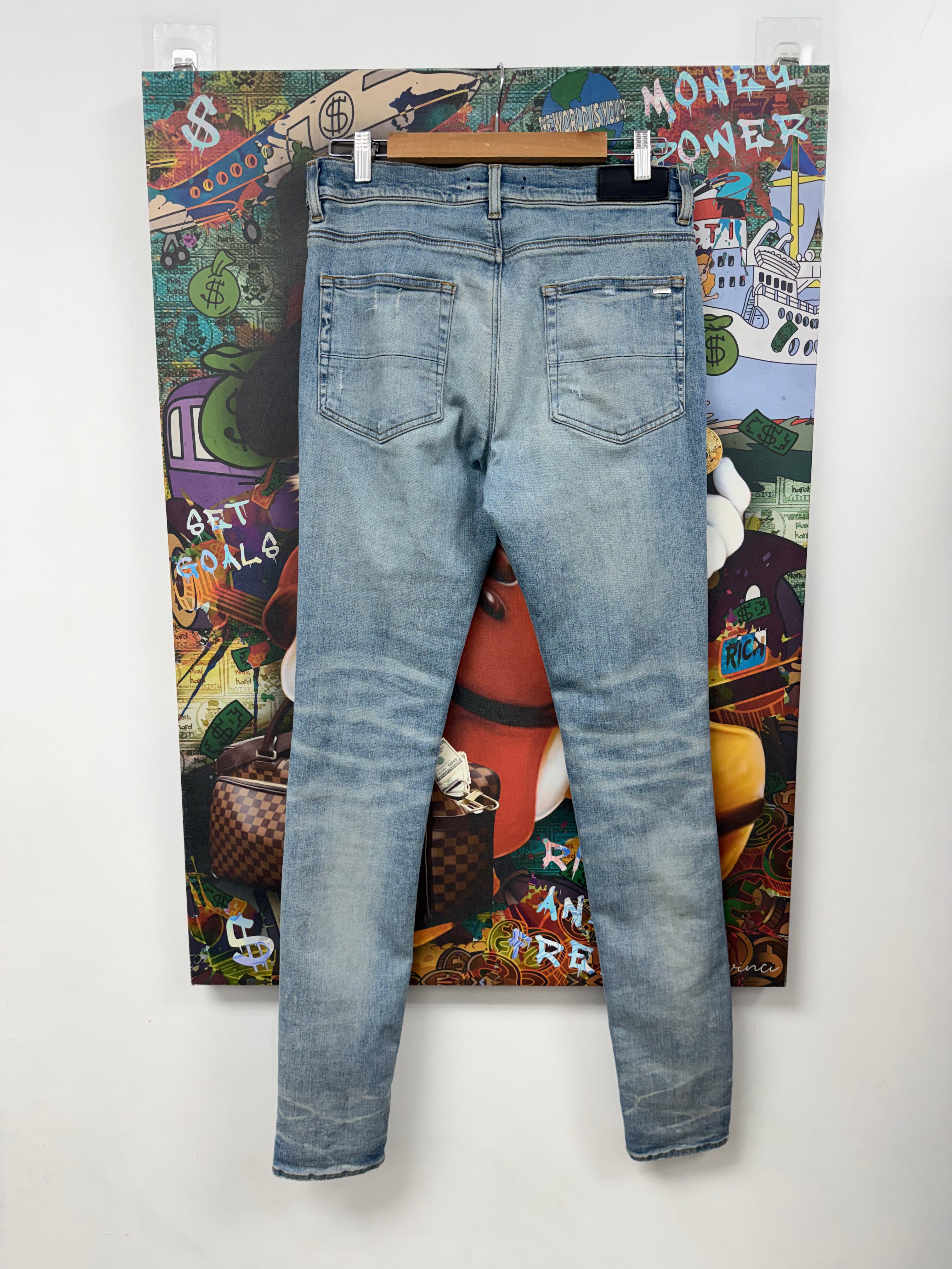 Amiri MX1 Light Wash Black Leather Patch Jeans