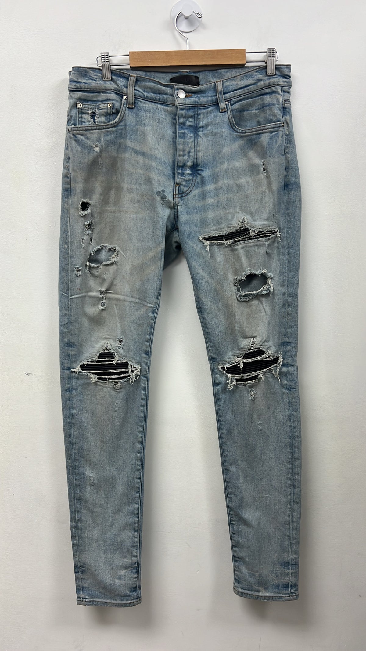 Amiri MX1 Light Indigo Black Patch Jeans (Glue Stain)