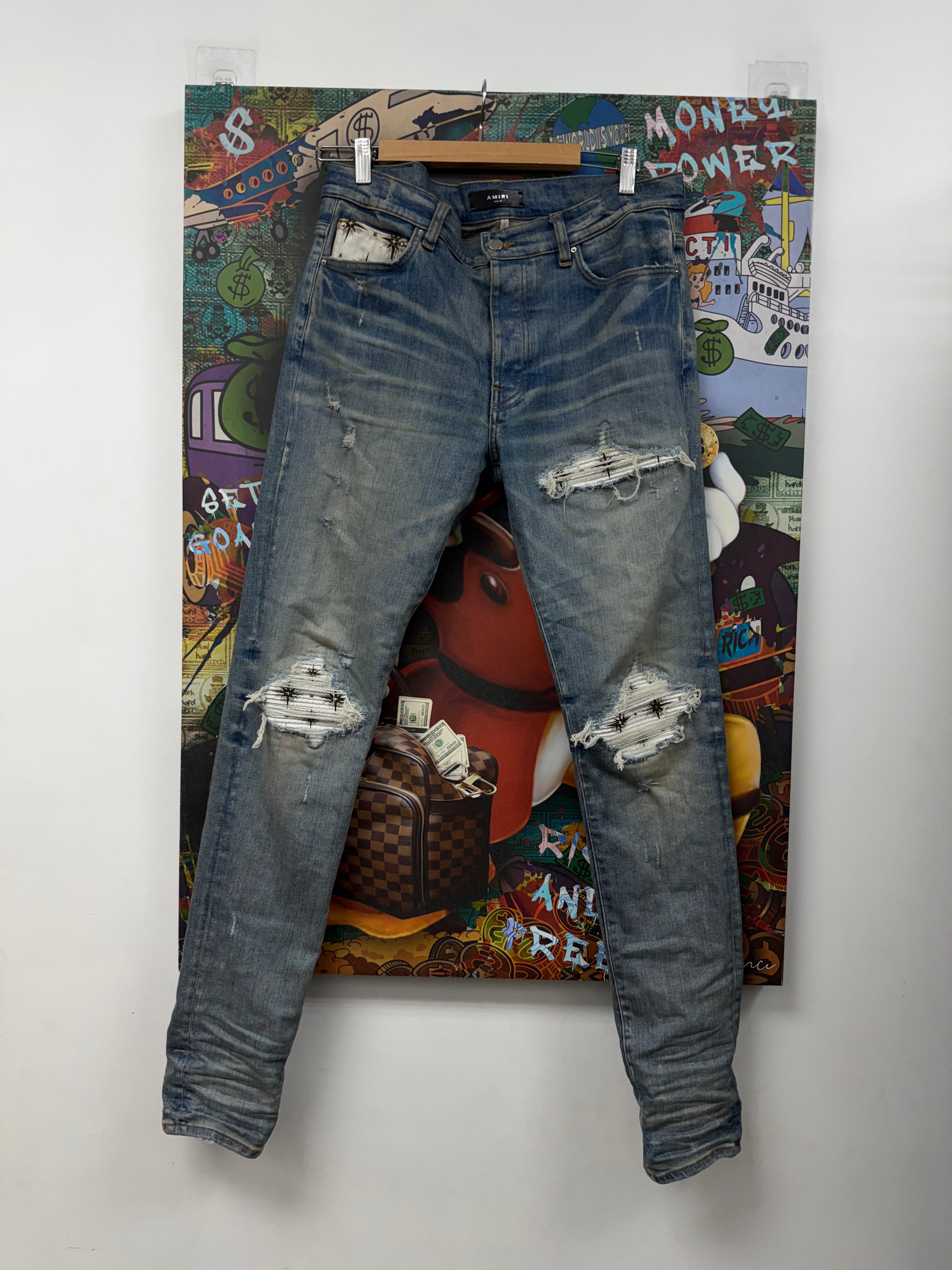 Amiri MX1 Light Wash White Starburst Patch Jeans