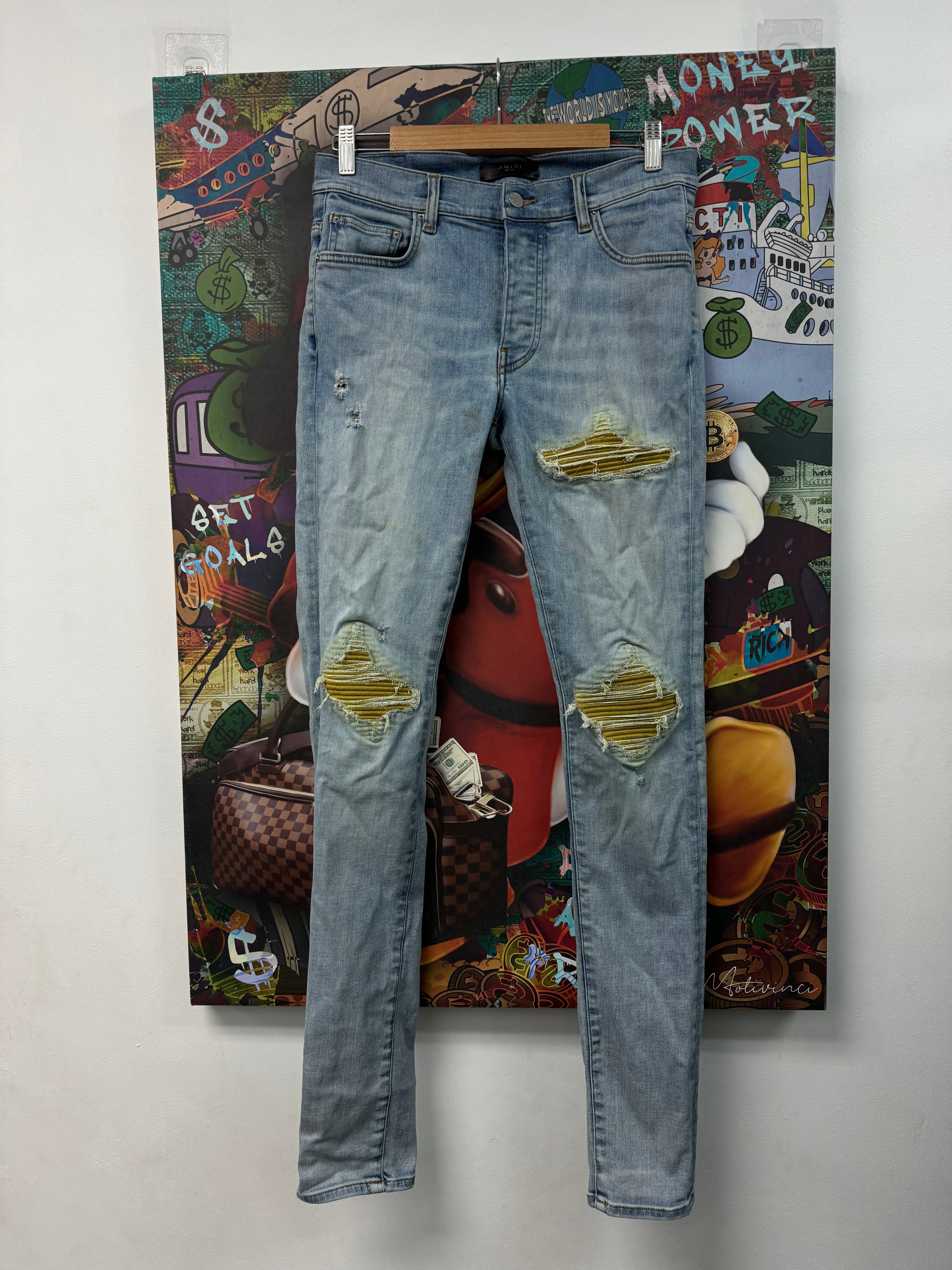 Amiri MX1 Light Wash Sun Dust Patch Jeans