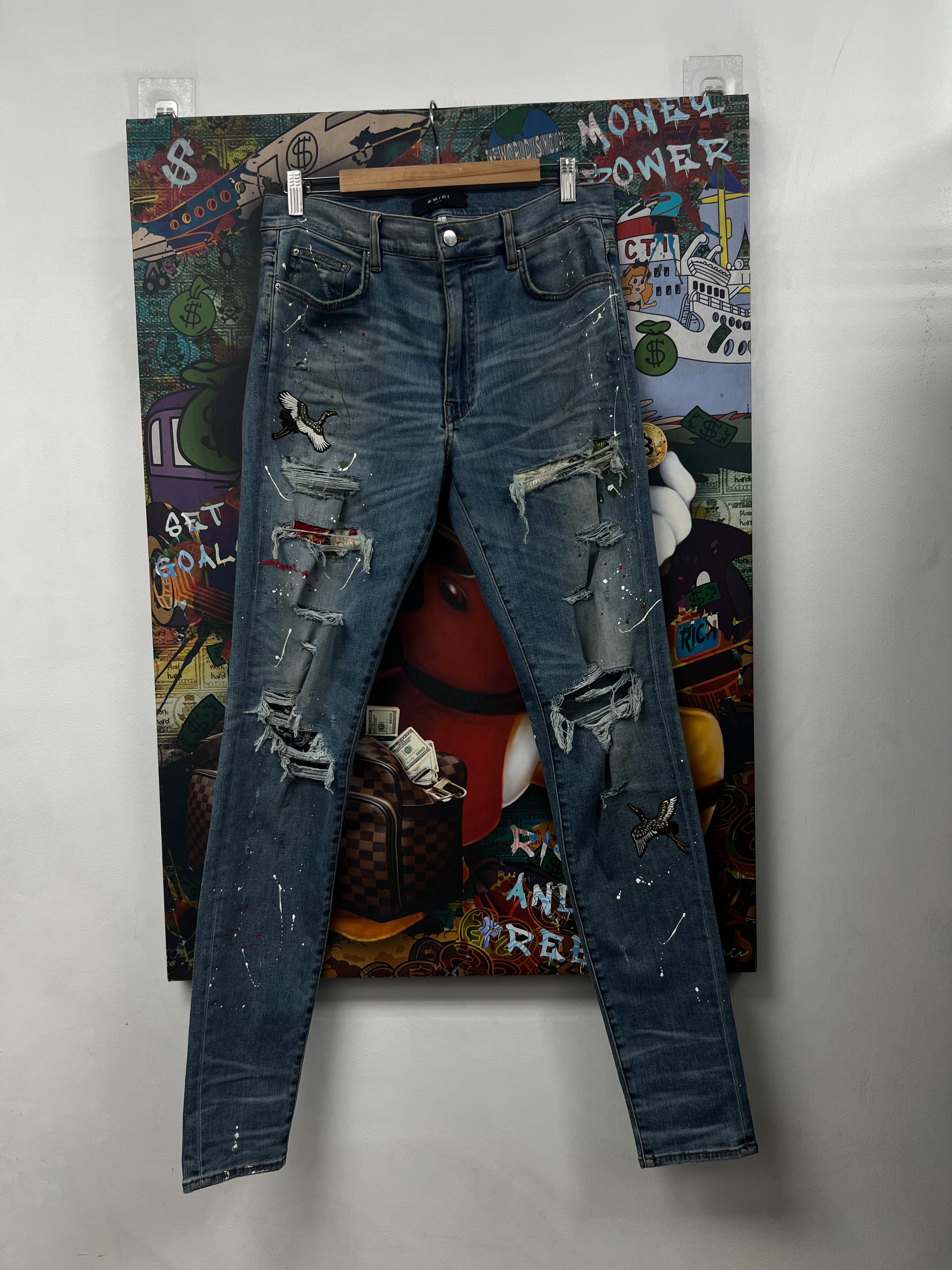 Amiri Light Wash Splatter Swan Patch Jeans