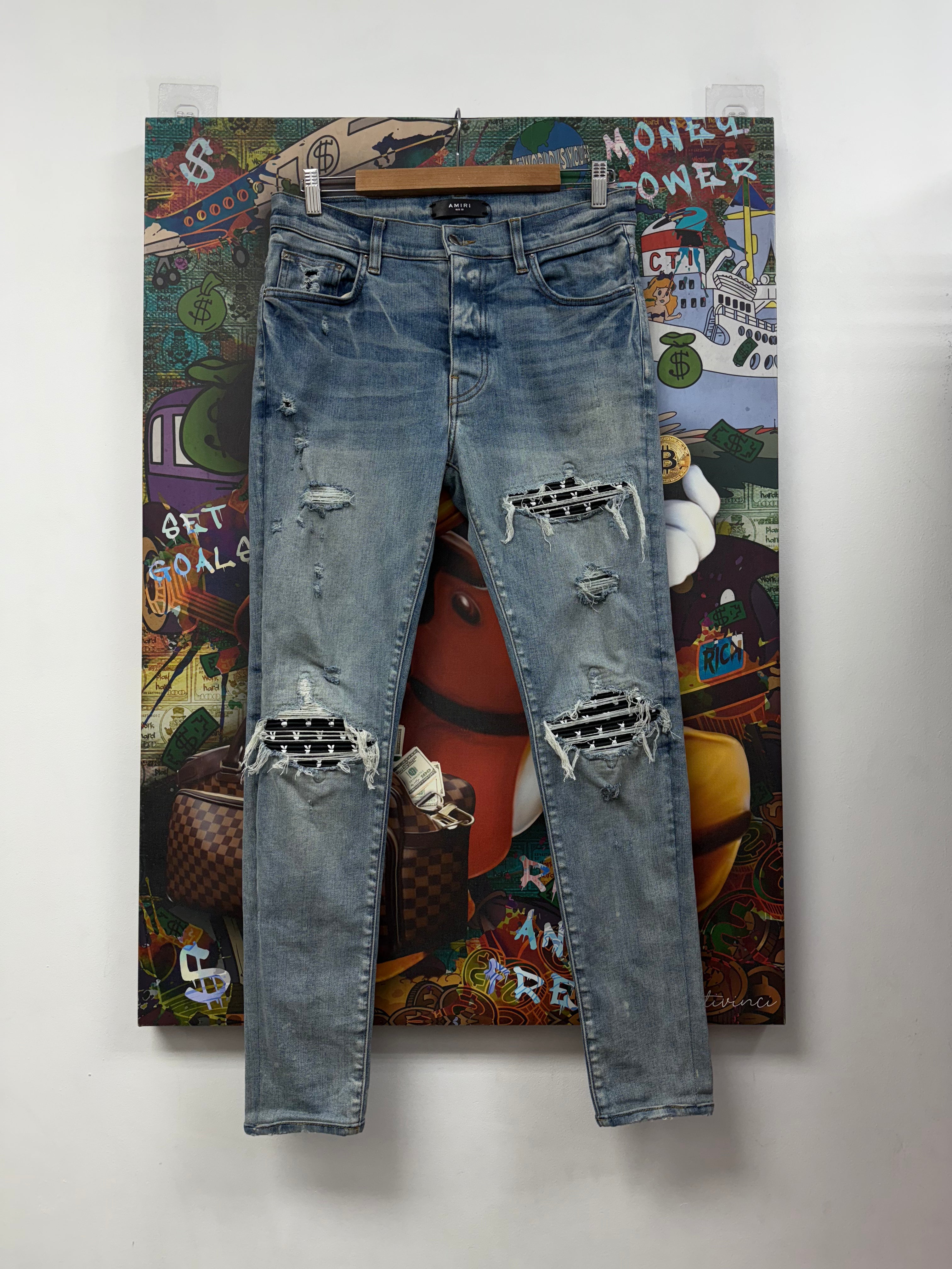 Amiri MX1 Light Wash Black Playboy Patch Jeans