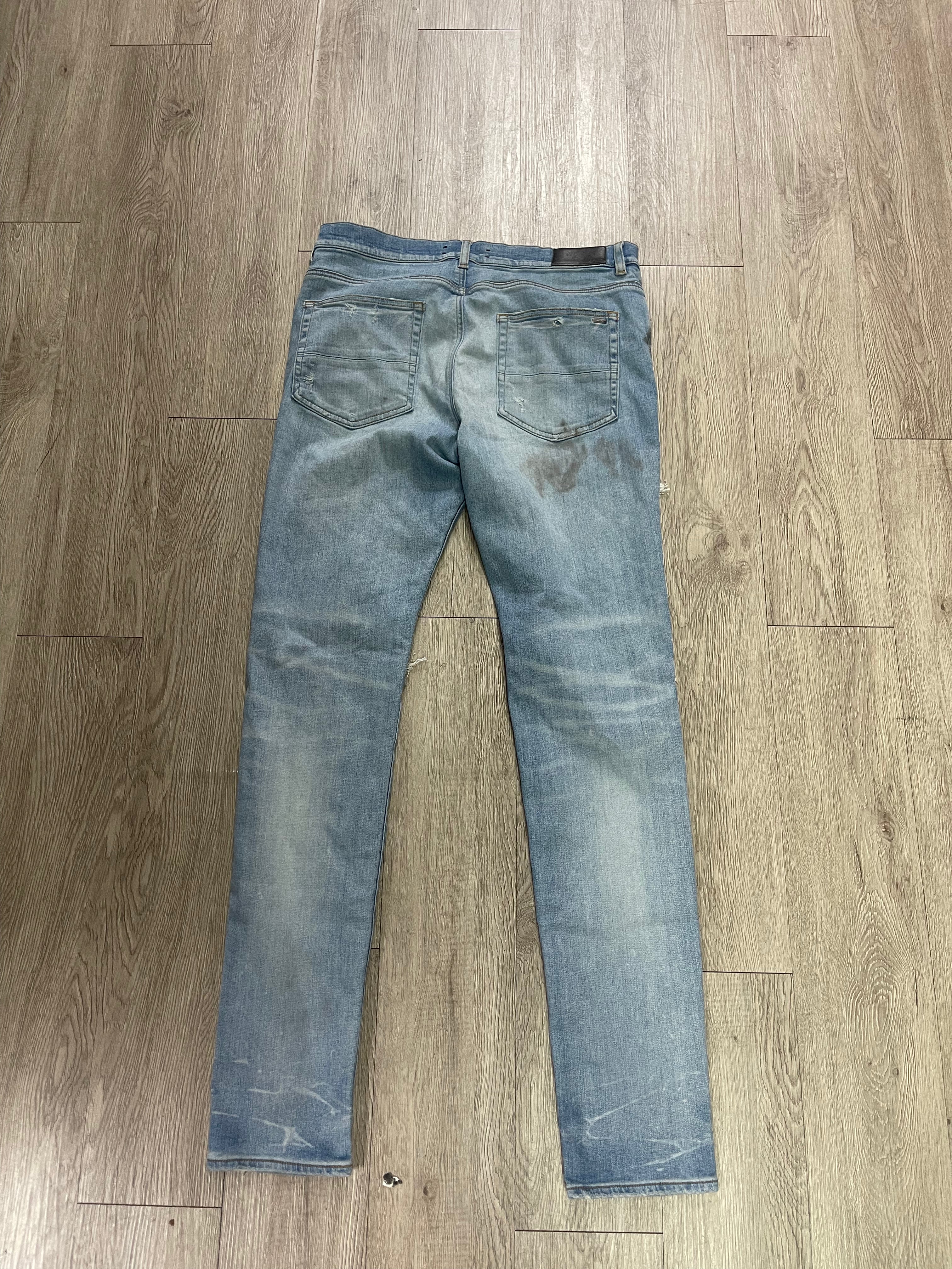 Amiri Light Wash Ripped Thrasher Jeans