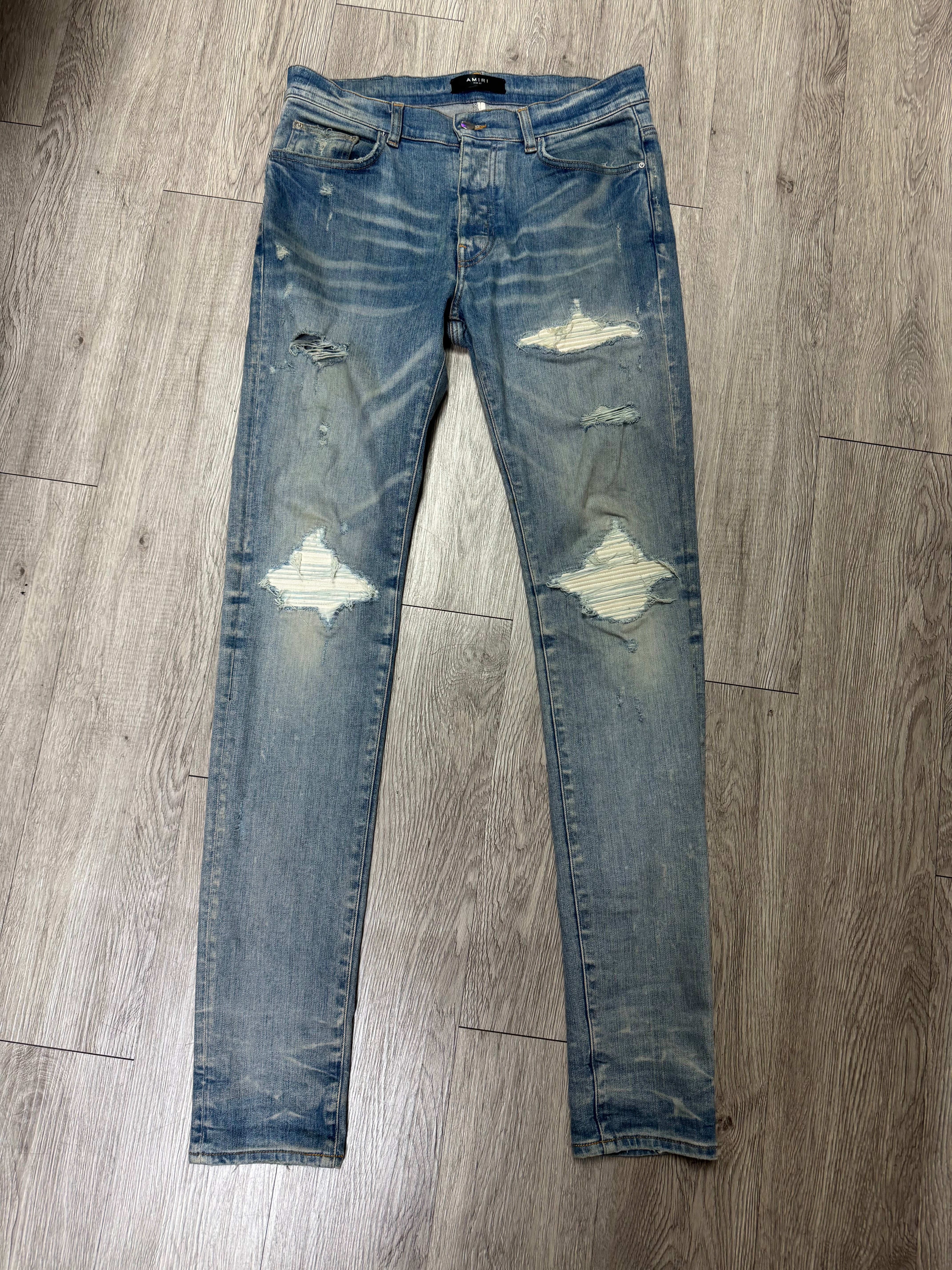 Amiri MX1 Light Wash White Patch Jeans