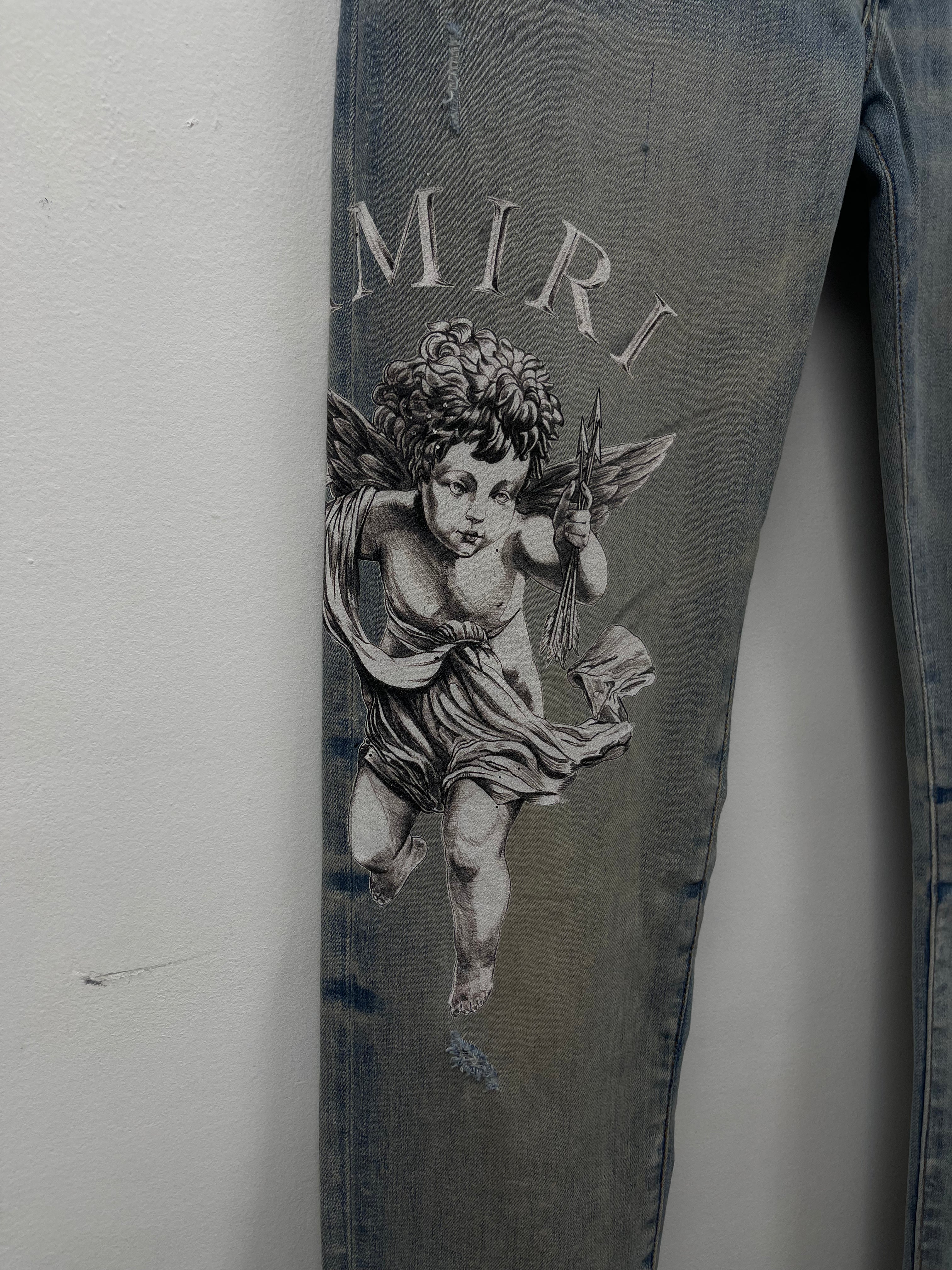 Amiri Light Wash Cherub Ripped (Oil Stain) Jeans