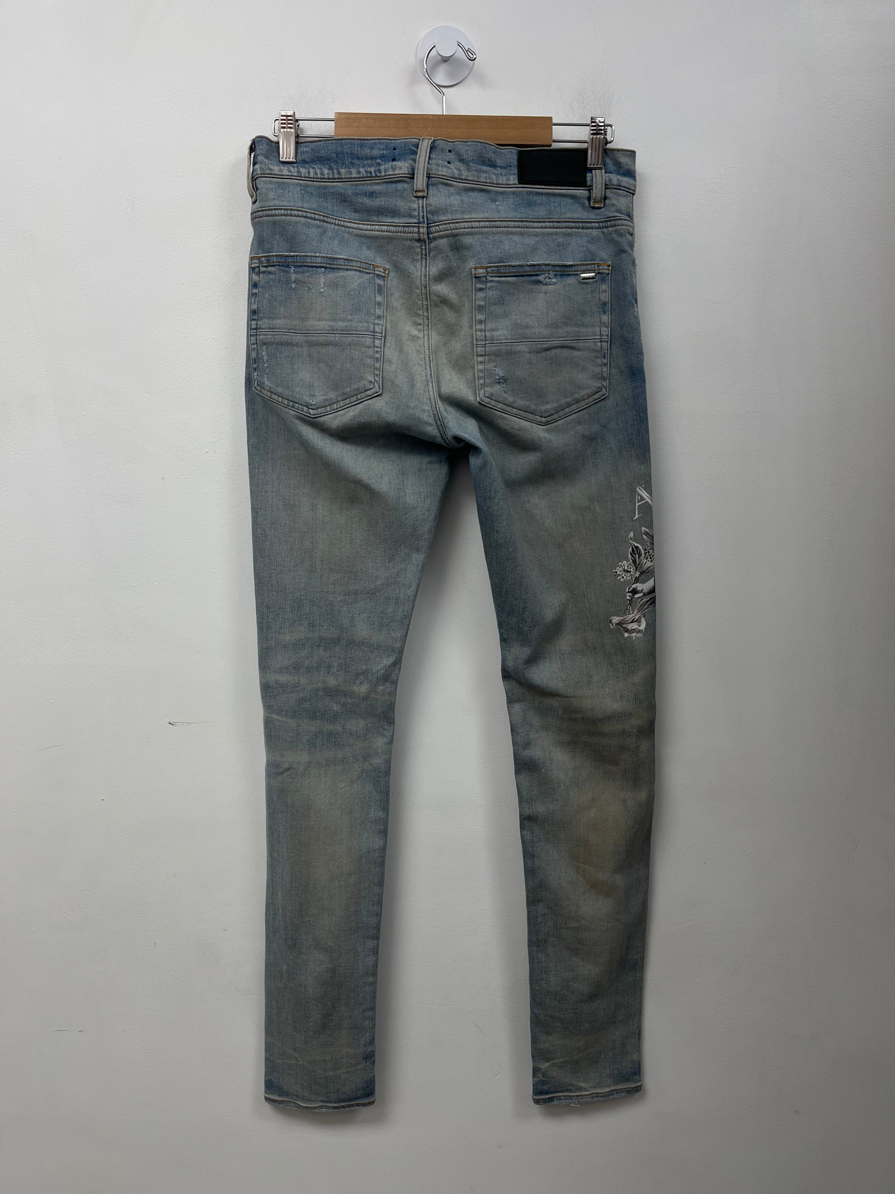 Amiri Light Wash Cherub Ripped (Oil Stain) Jeans