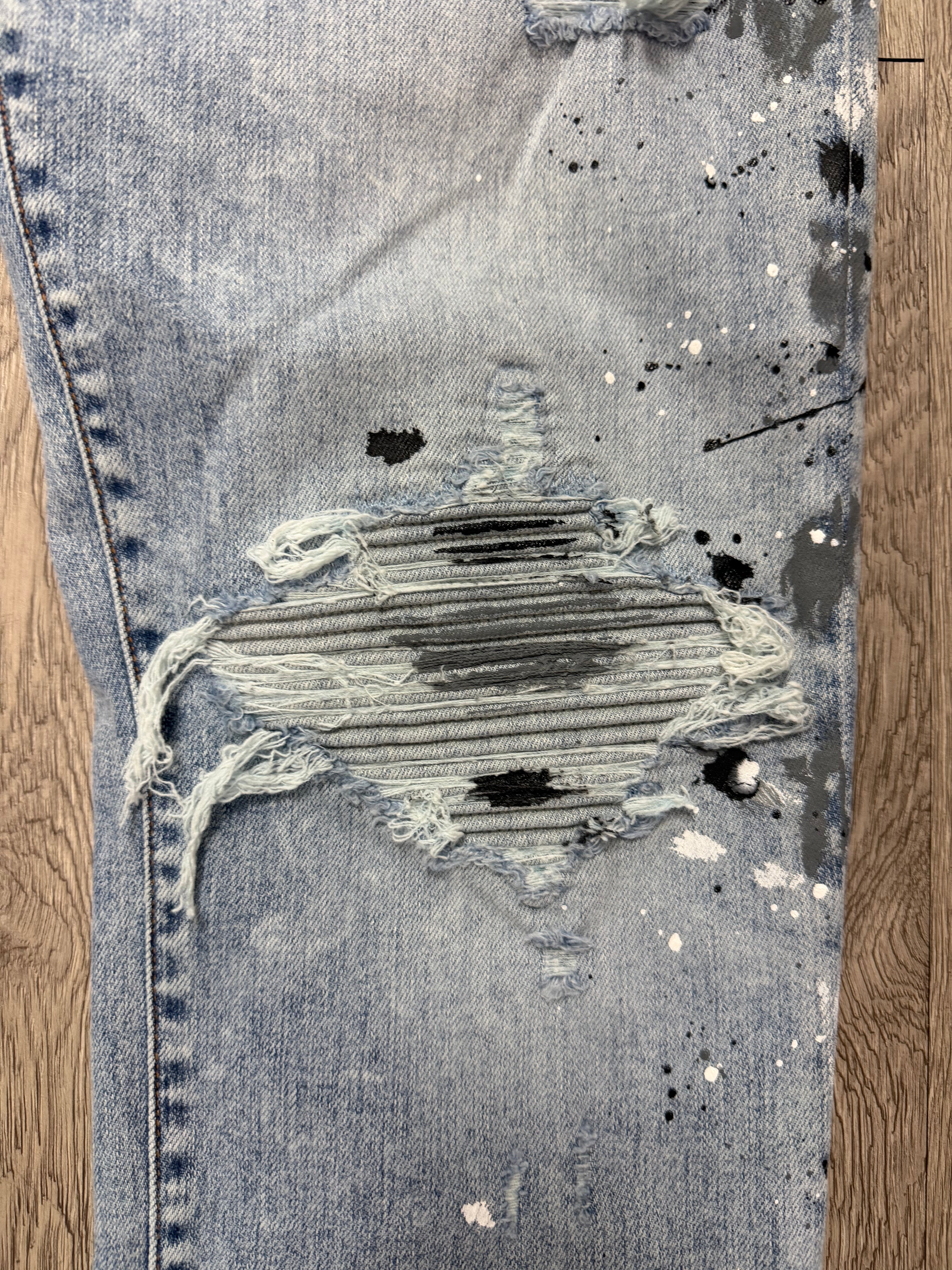 Amiri MX1 Light Wash Paint Splatter Jeans