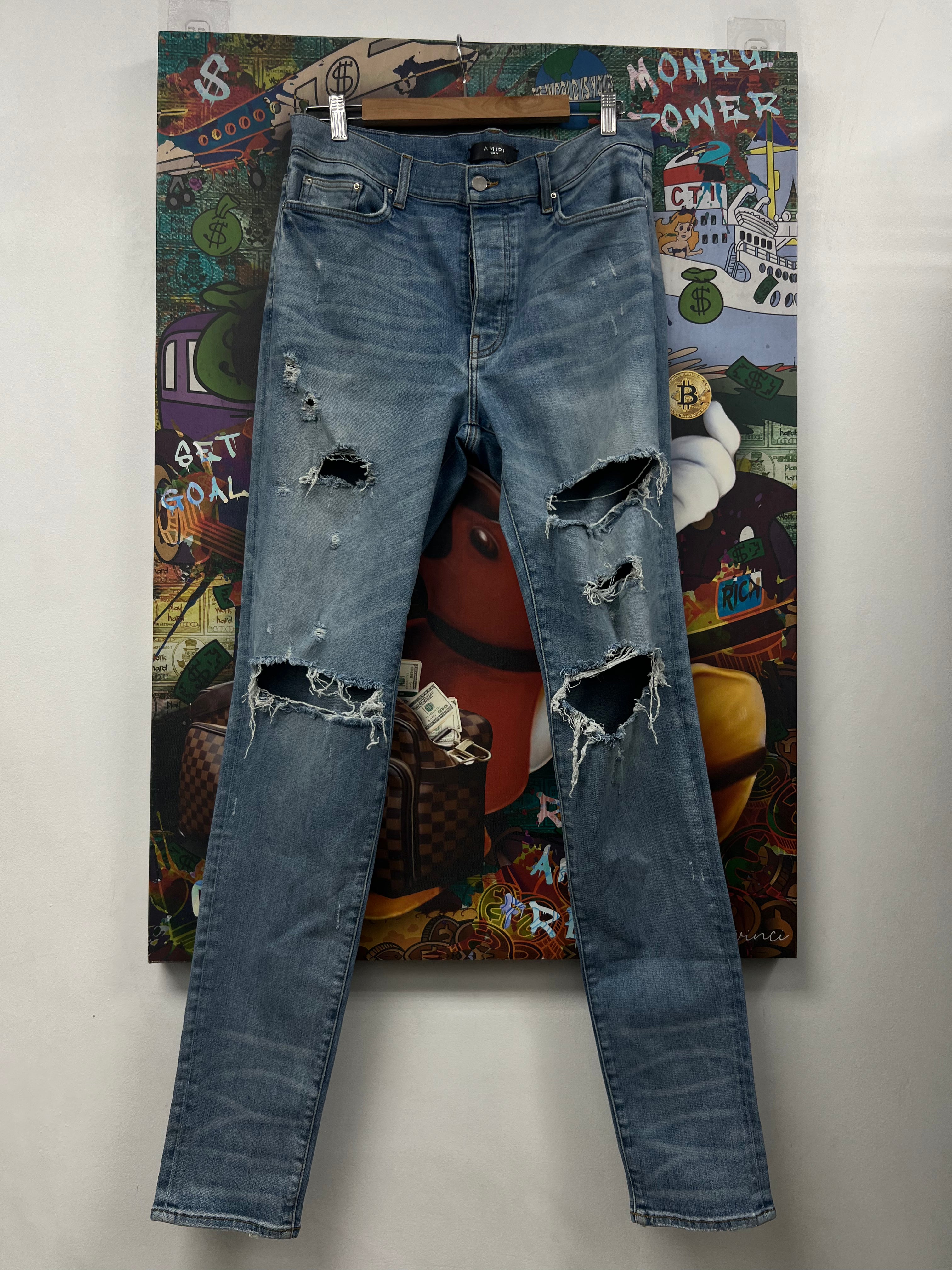 Amiri Light Wash Ripped Thrasher Jeans