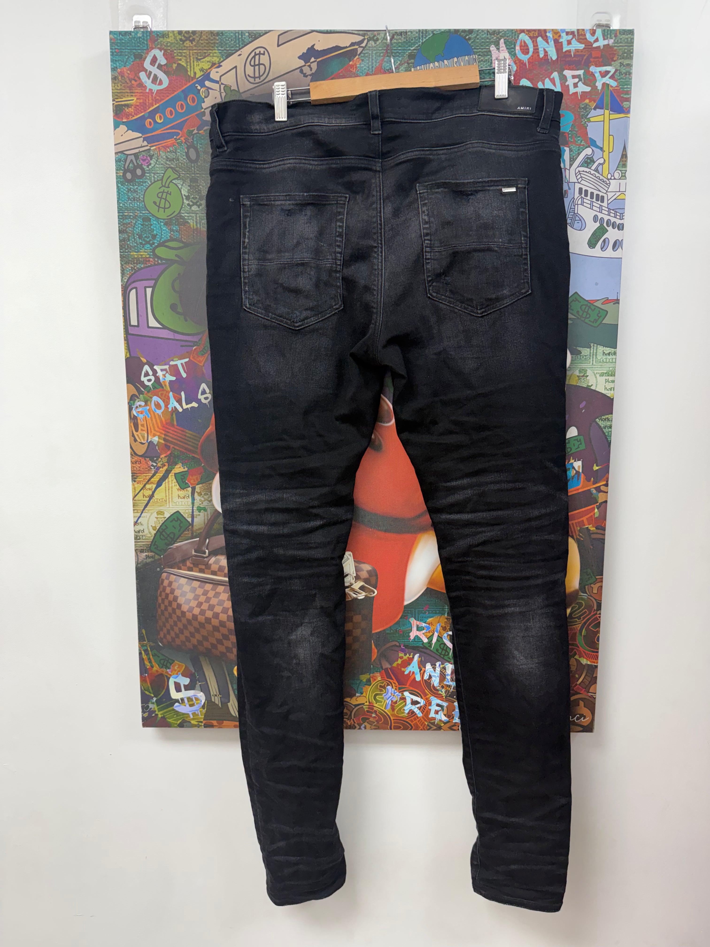 Amiri Black Wash Red Tie Dye Thrasher Patch Jeans