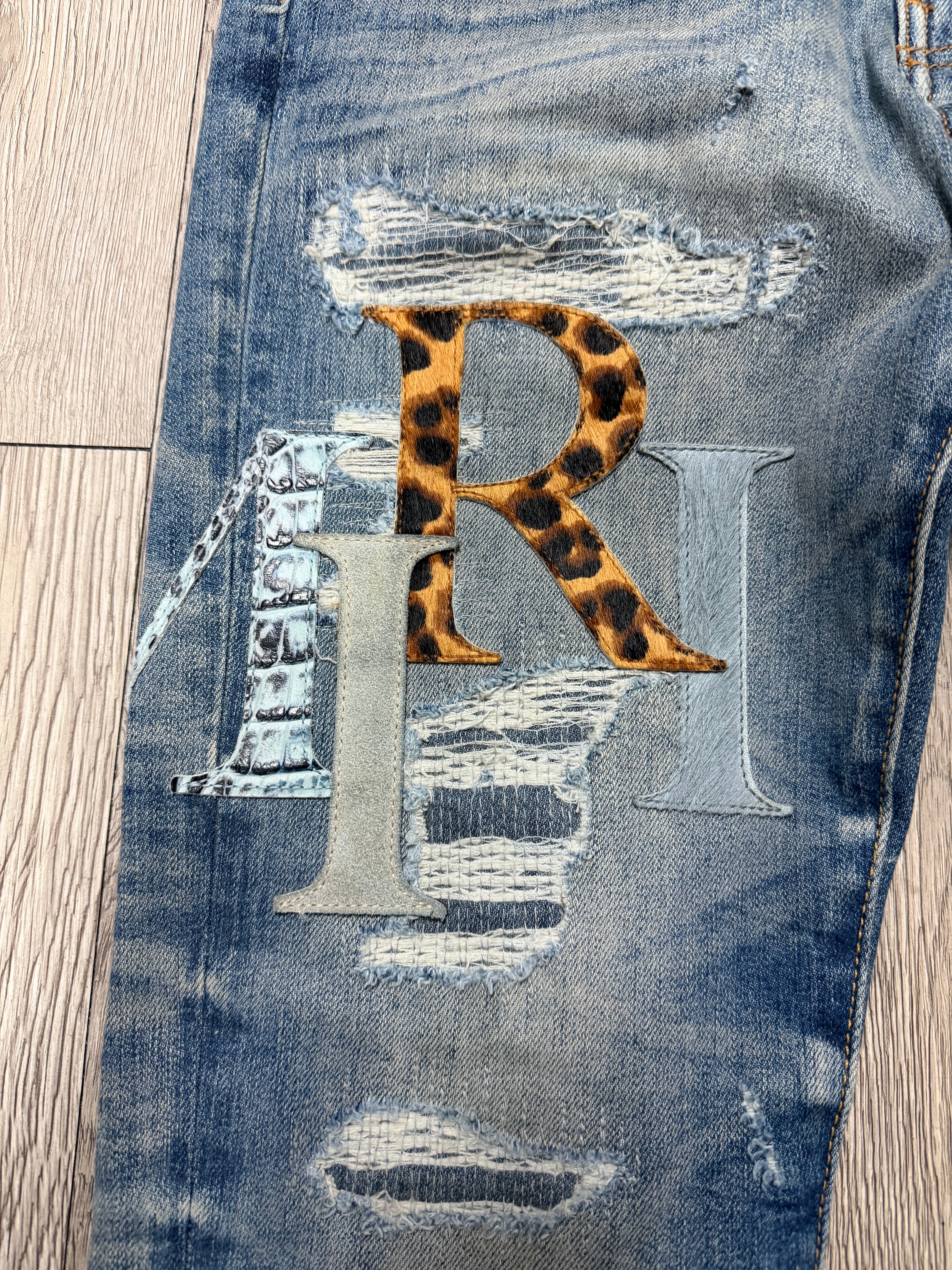 Amiri Light Wash Multi Staggered Side Logo Jeans