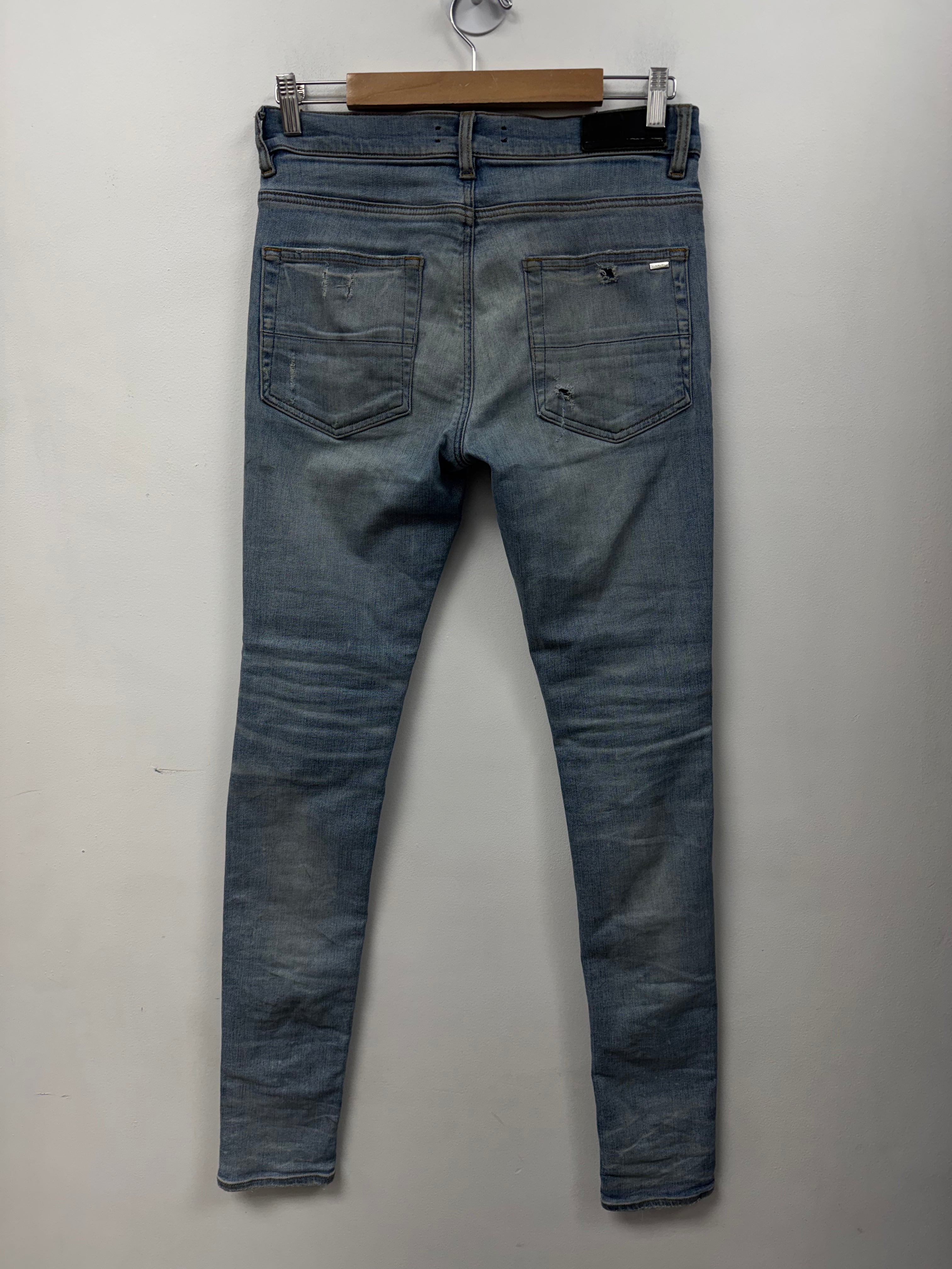 Amiri MX1 Light Wash Black Leather Patch Jeans
