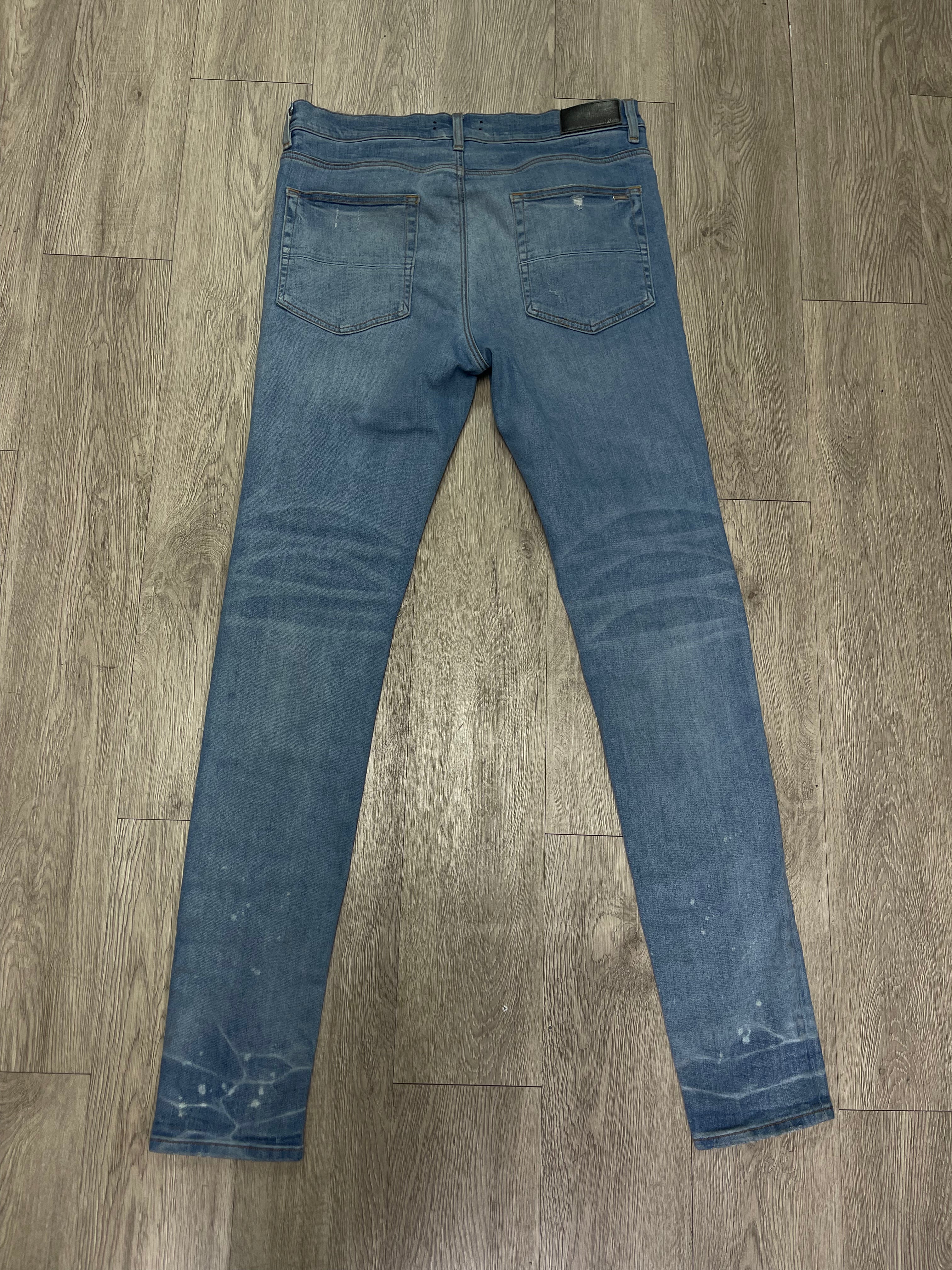 Amiri MX1 Light Wash Black Leather Playboy Patch Jeans