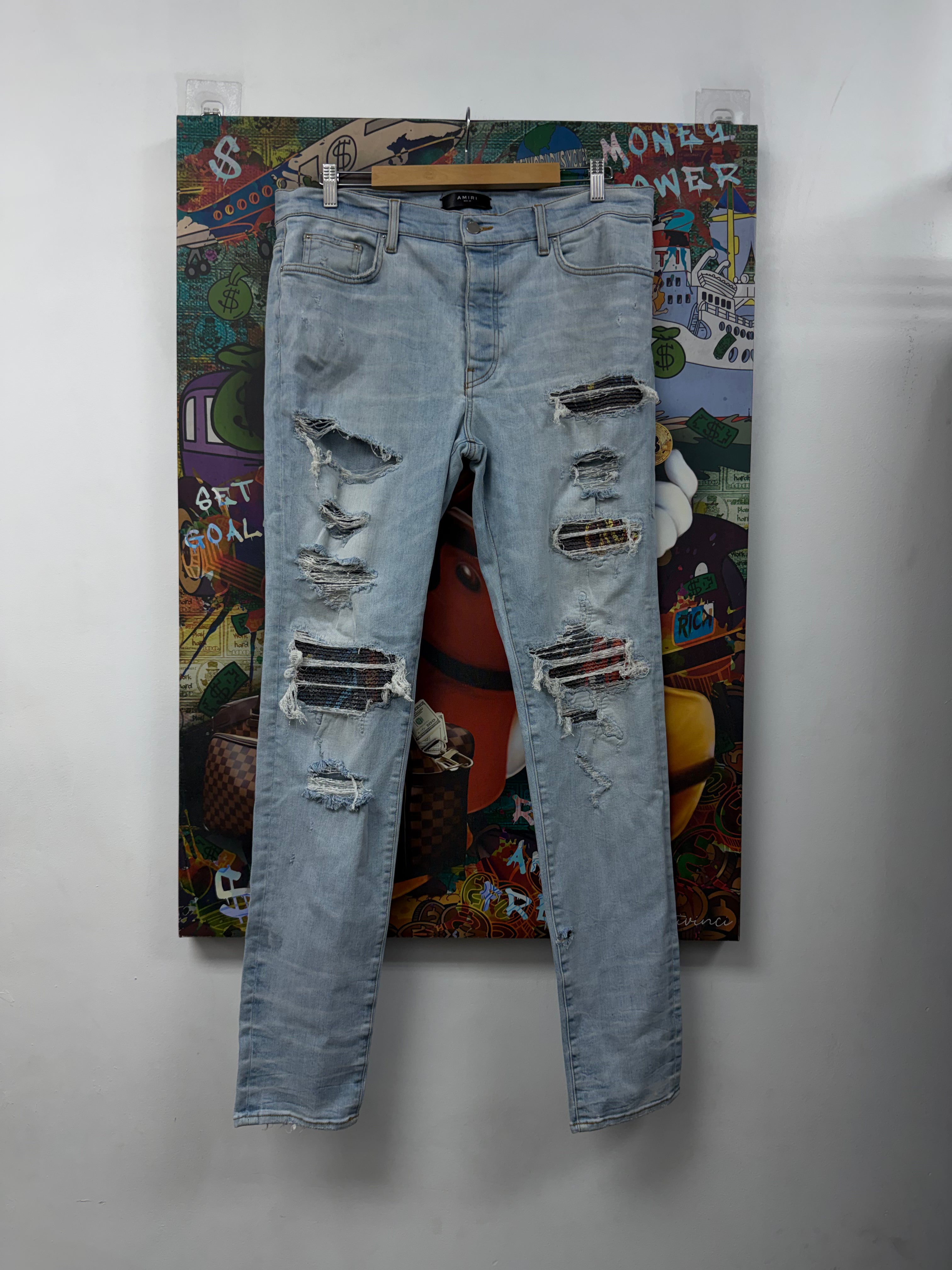 Amiri Light Wash Animation Thrasher Patch Jeans