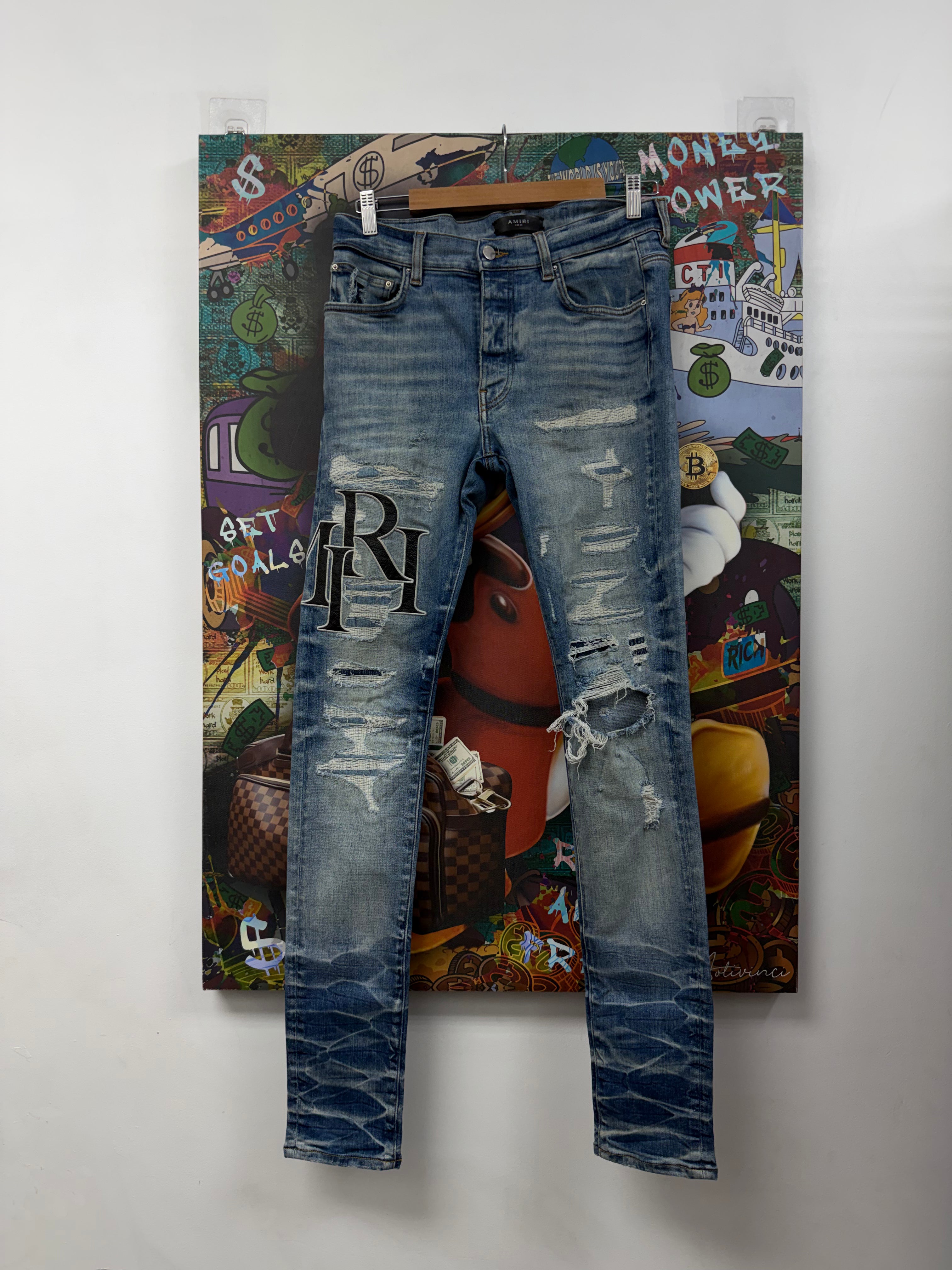 Amiri Light Wash Distressed Black Leather Staggered Logo Jeans