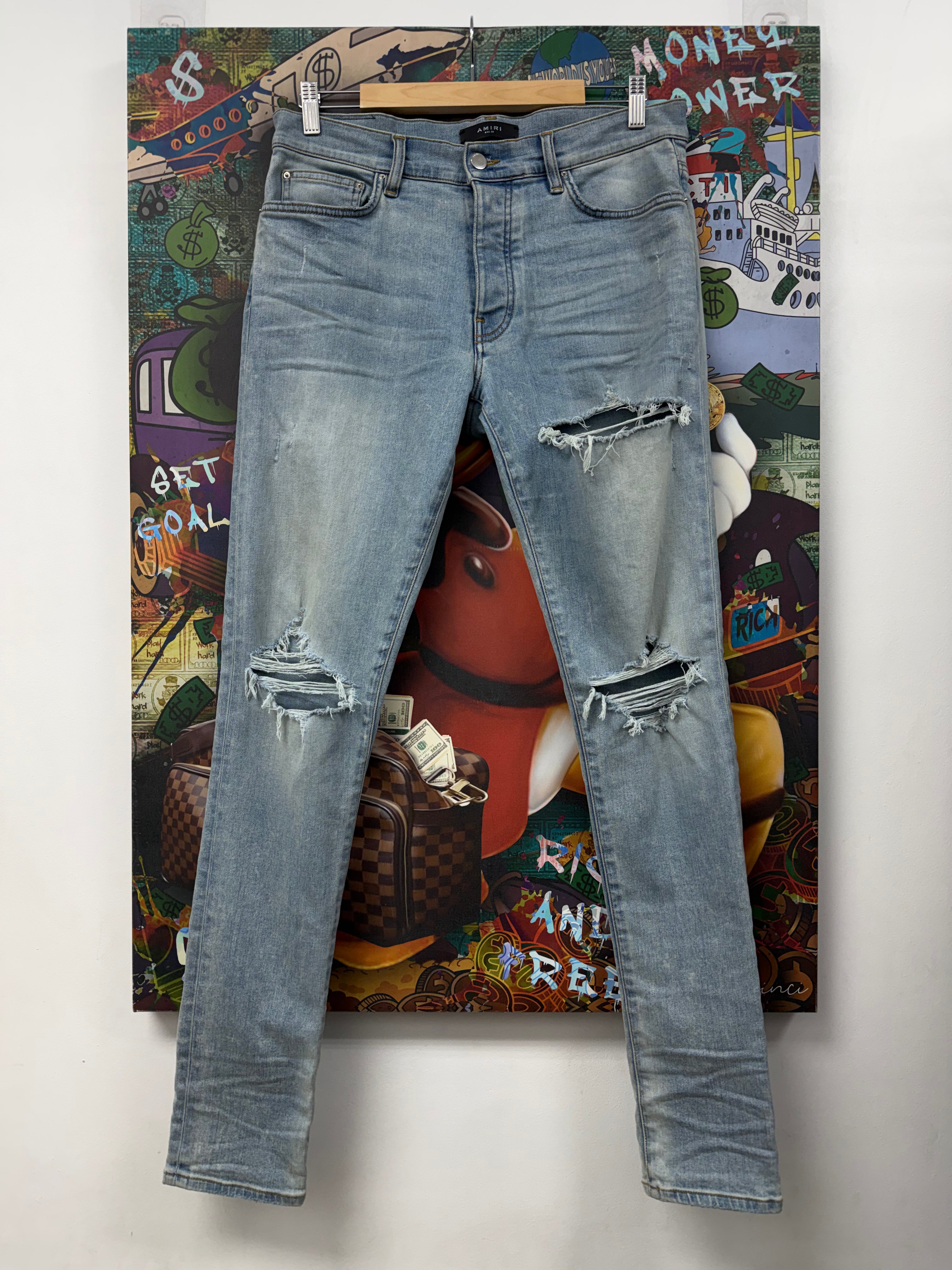 Amiri Light Wash Knee Rip Thrasher Jeans