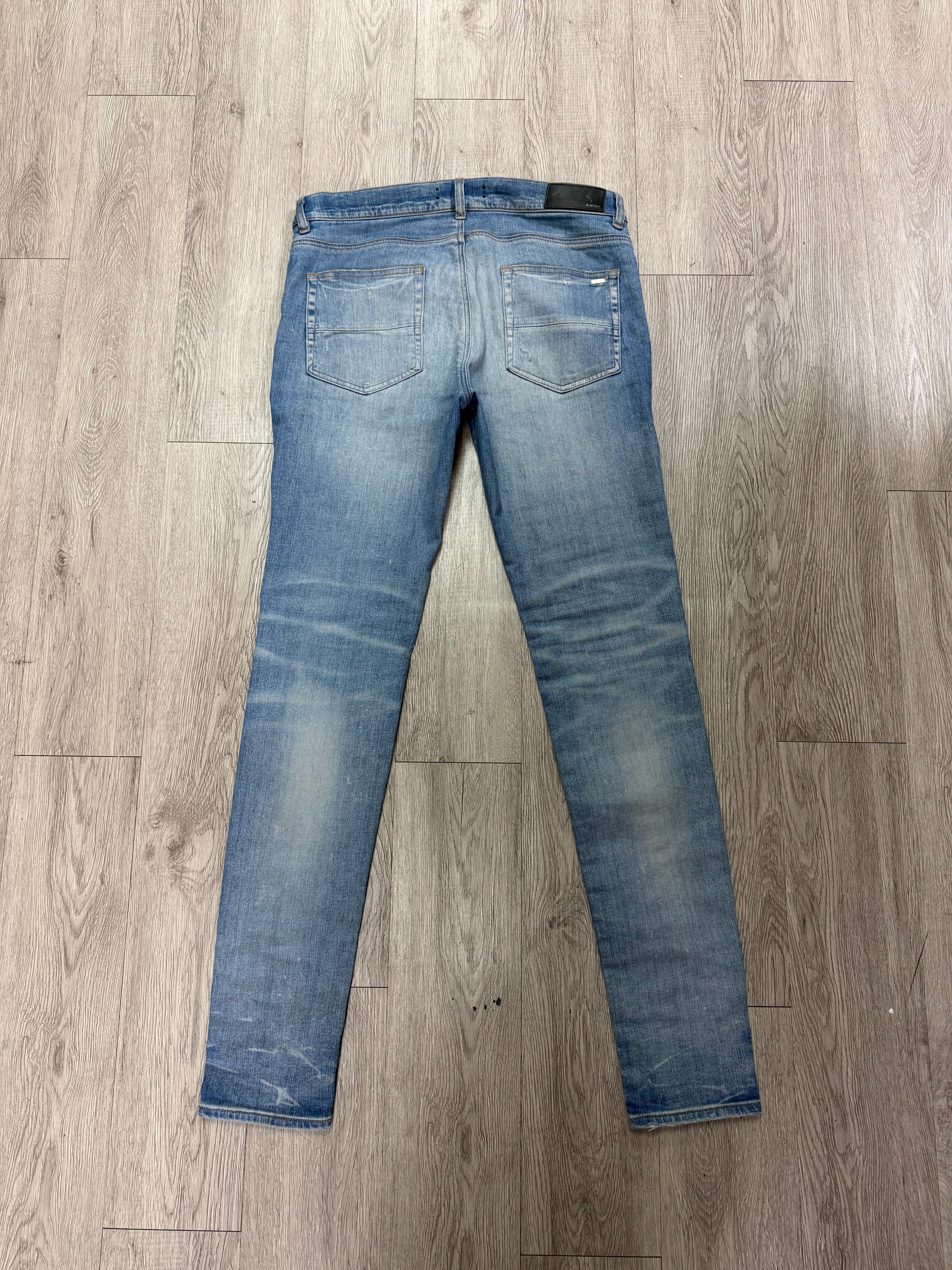 Amiri MX1 Light Wash White Patch Jeans