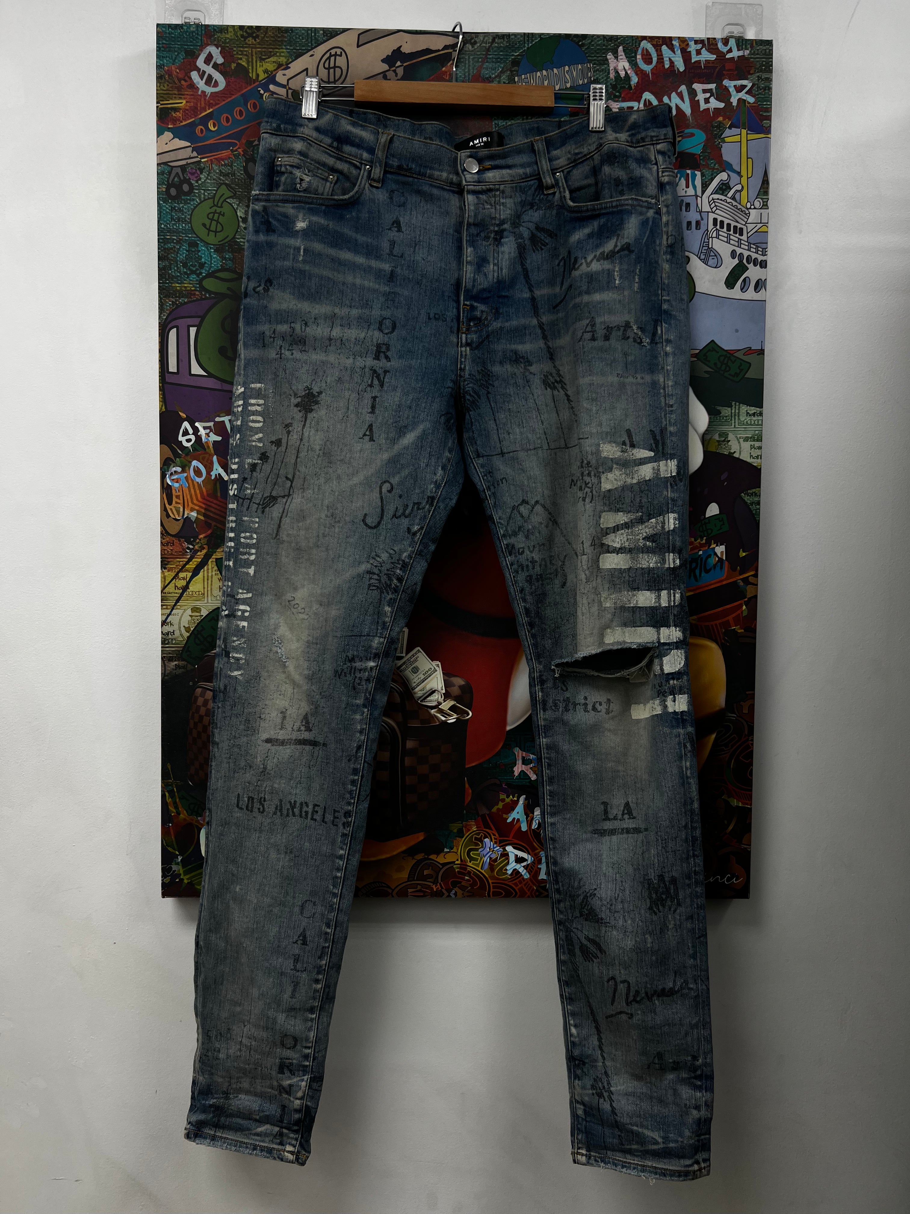 Amiri Light Wash All Over Writing Jeans