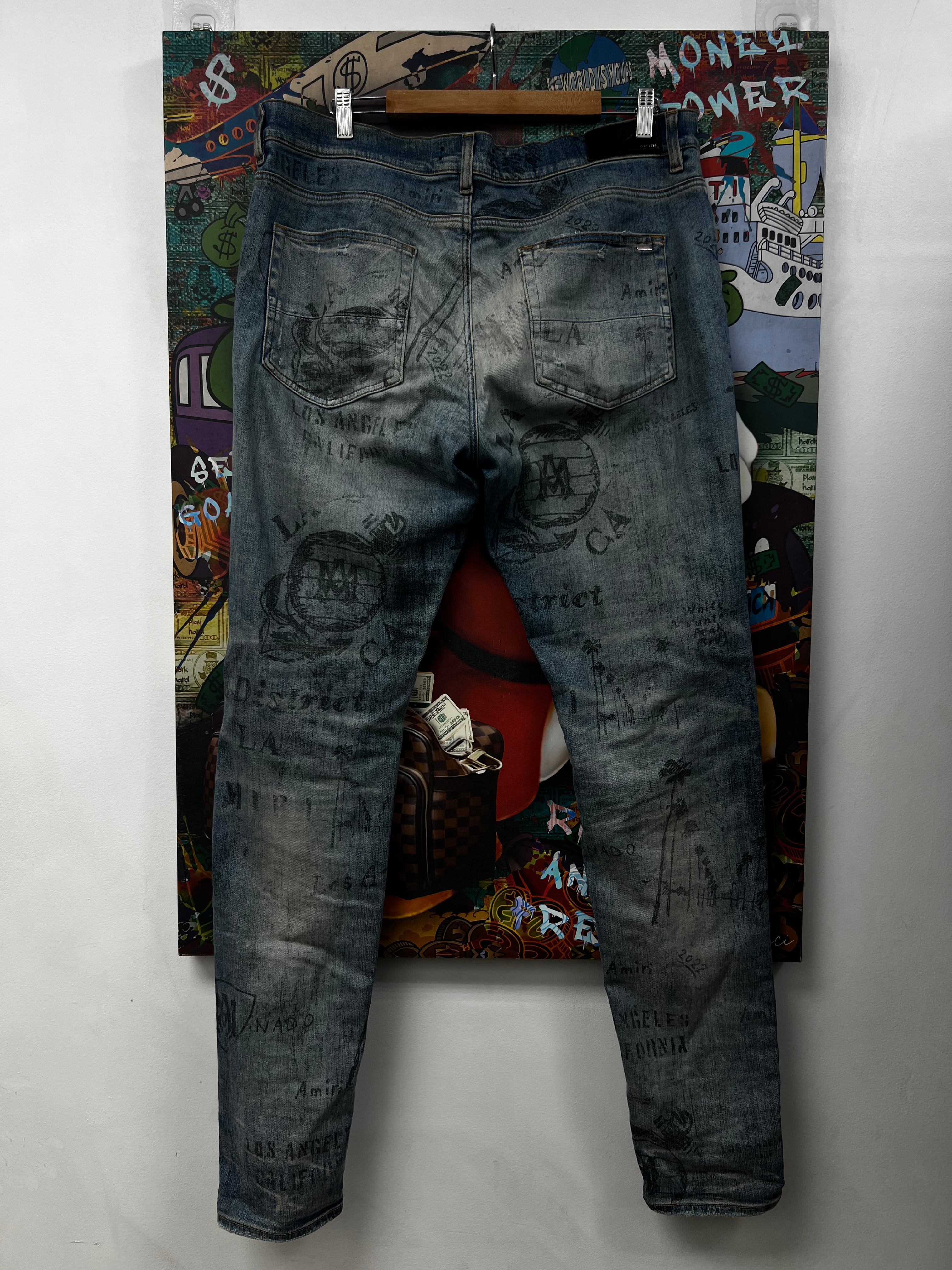 Amiri Light Wash All Over Writing Jeans