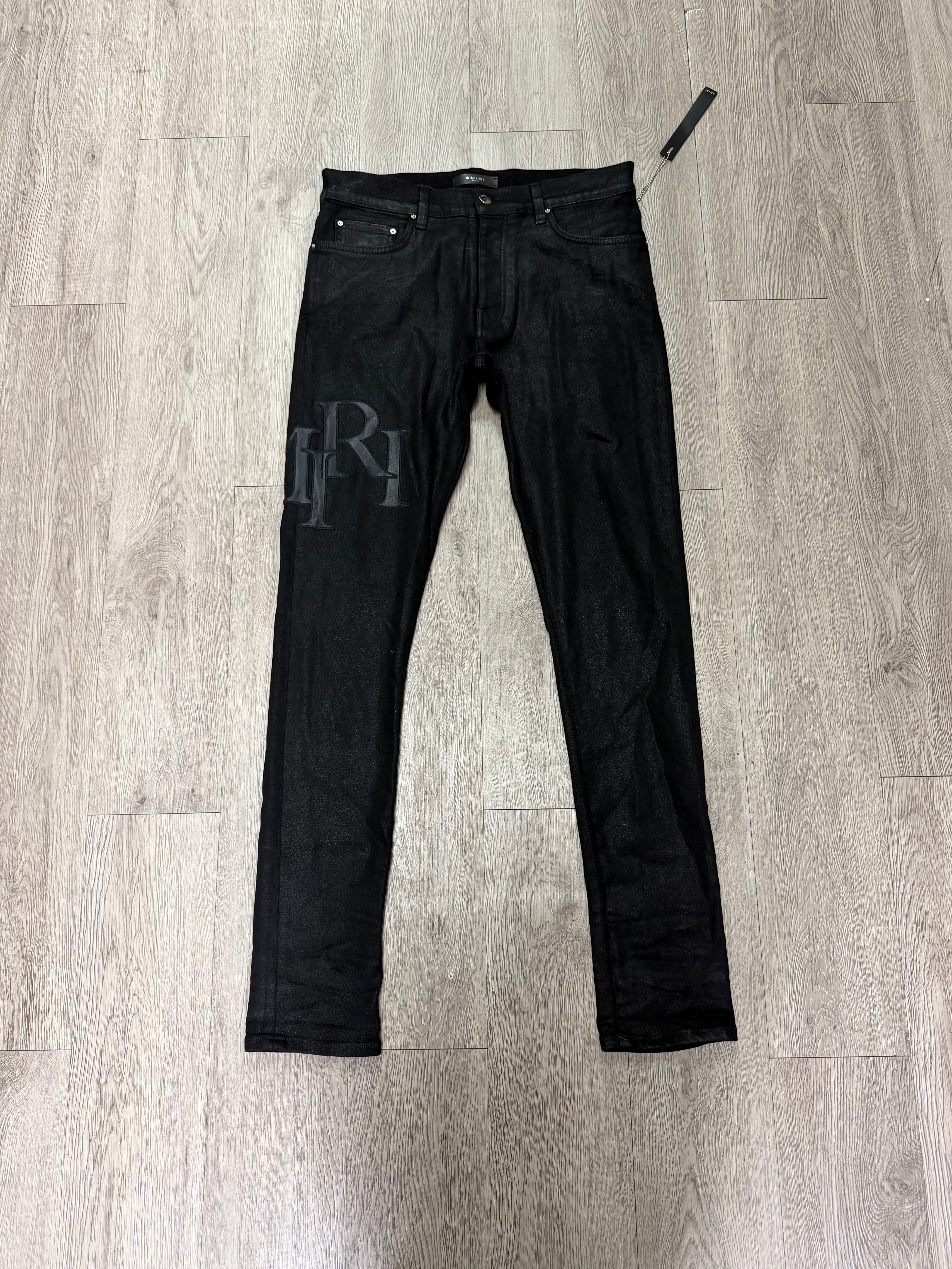 Amiri Black Wax Staggered Side Logo Jeans
