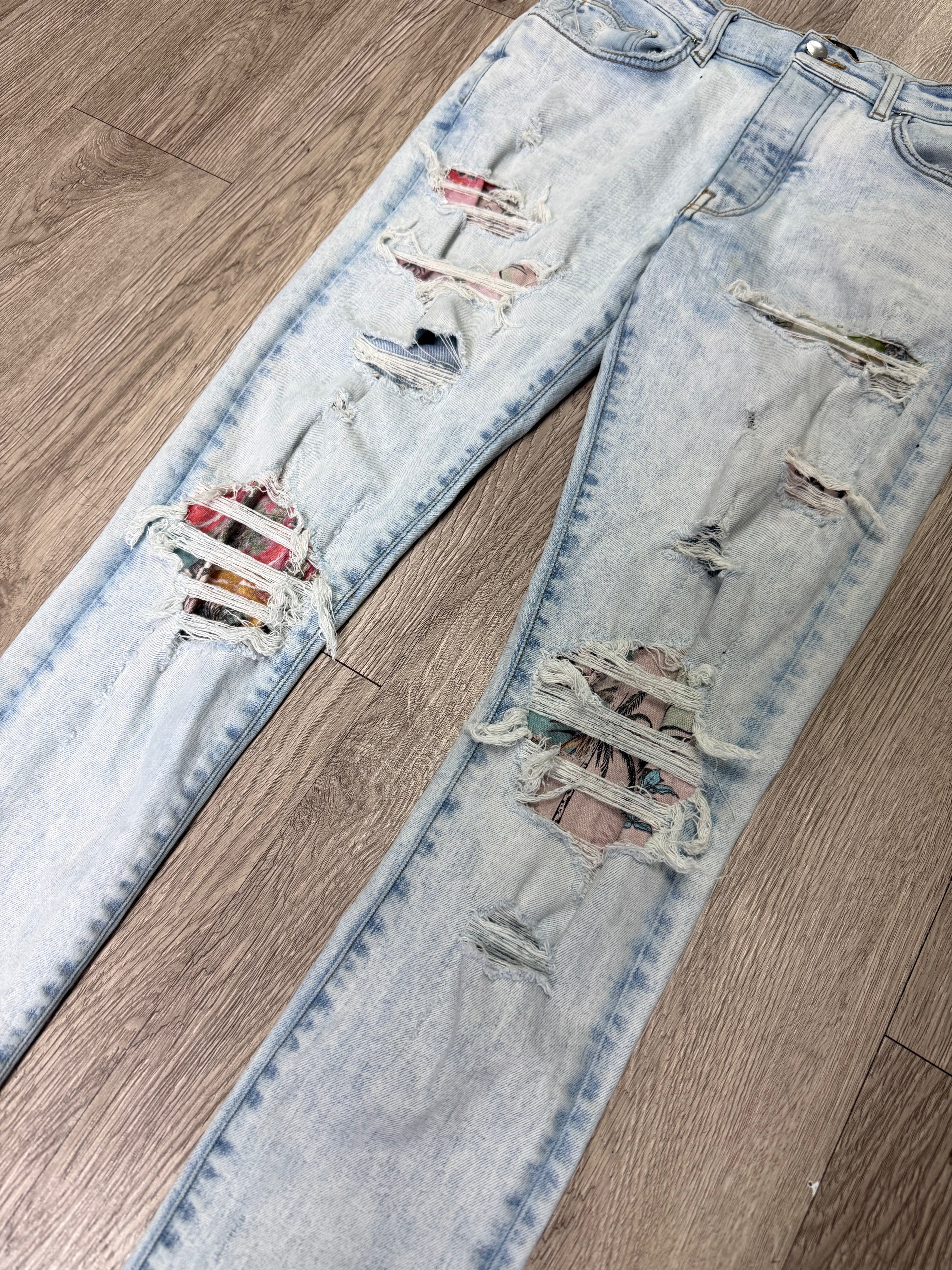 Amiri Light Wash Art Patchwork Thrasher Jeans
