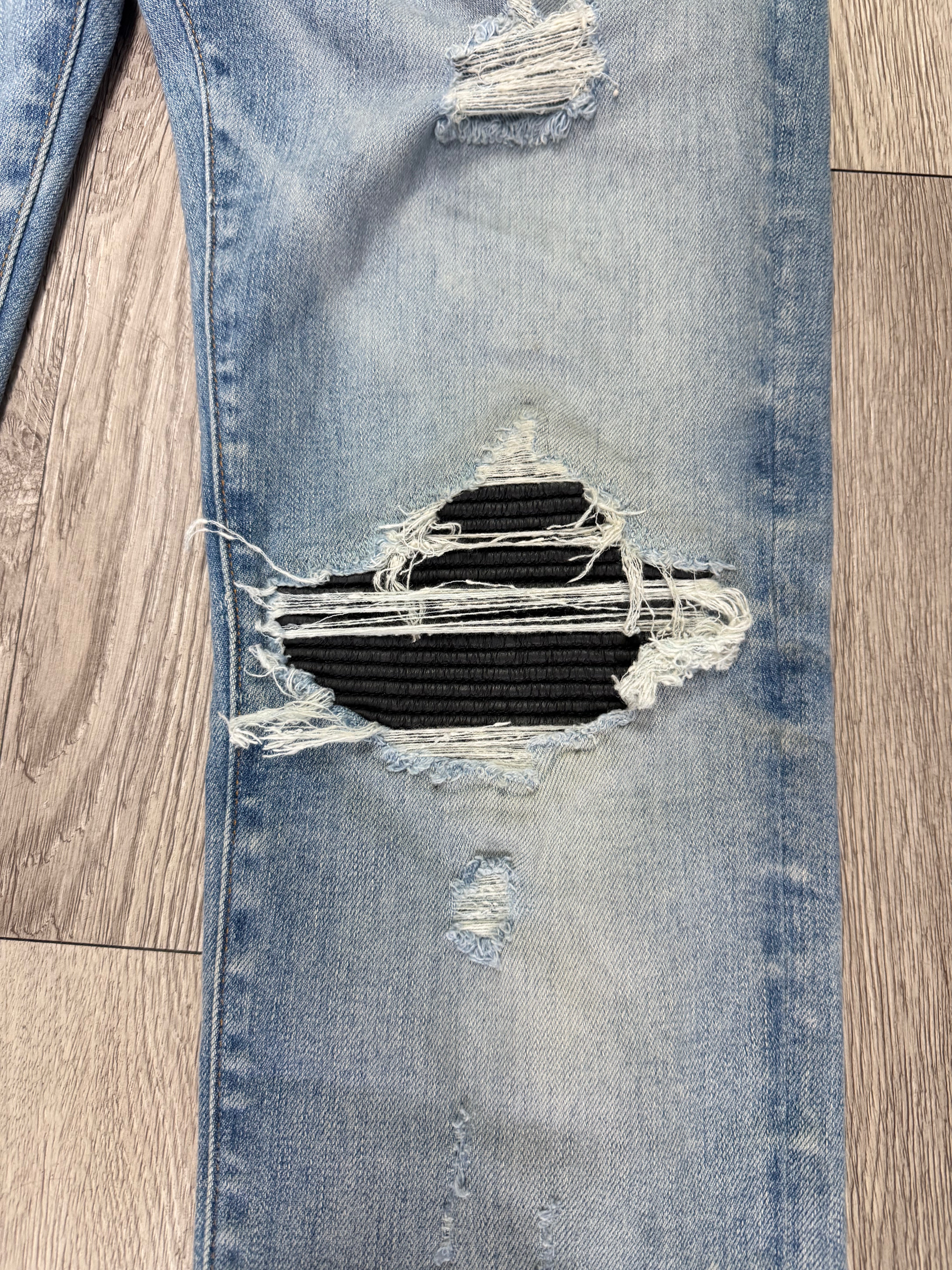 Amiri MX1 Light Wash Black Leather Patch Jeans