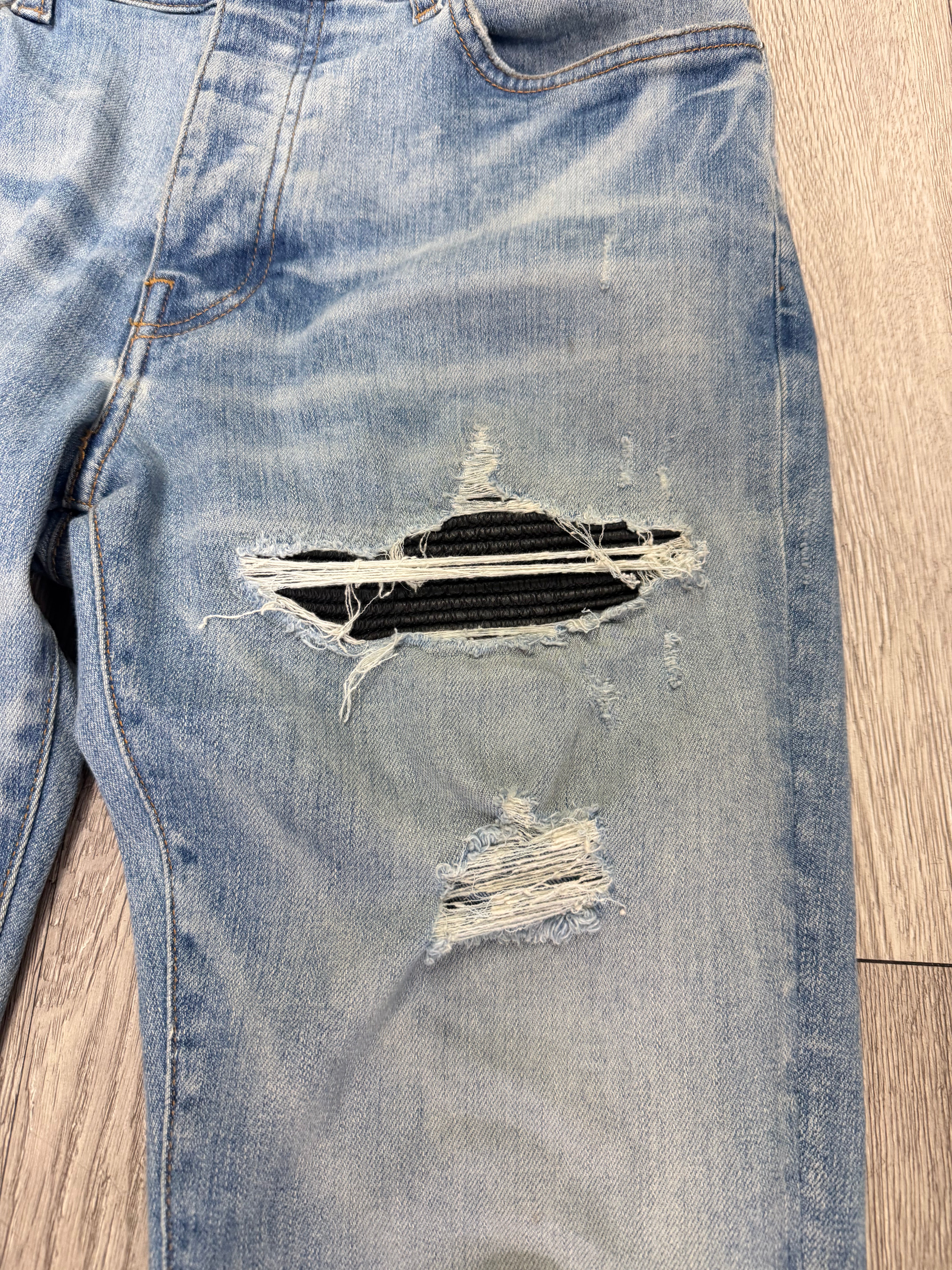 Amiri MX1 Light Wash Black Leather Patch Jeans