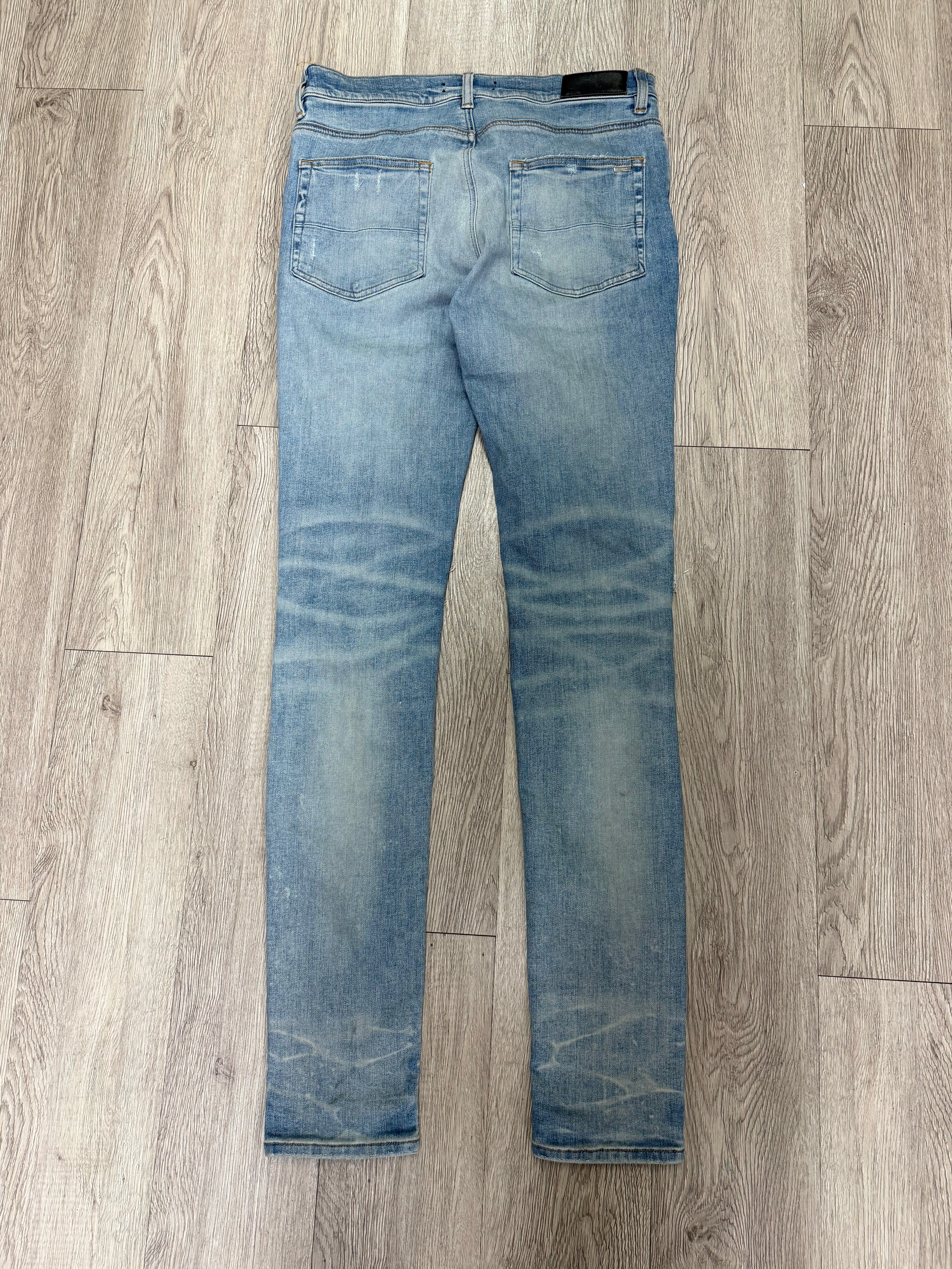 Amiri MX1 Light Wash Black Leather Patch Jeans