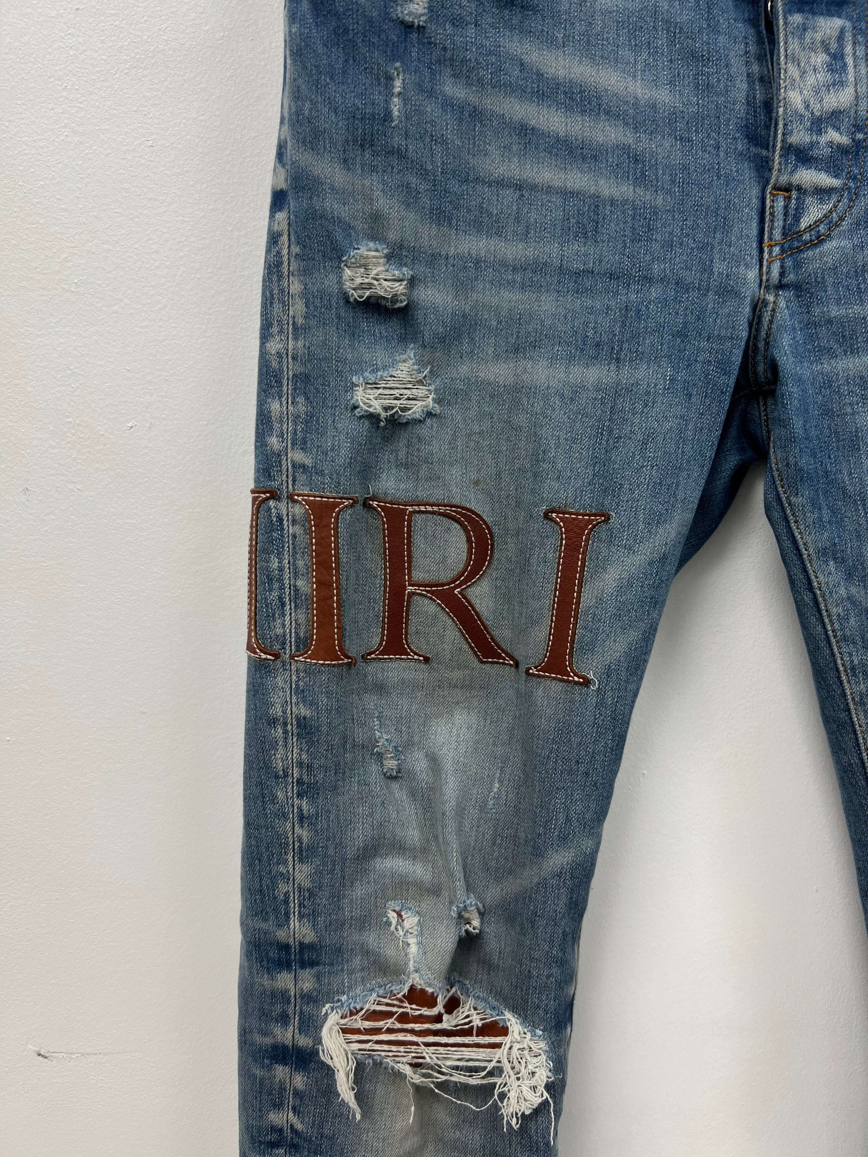 Amiri Light Wash Clay Side Logo Jeans