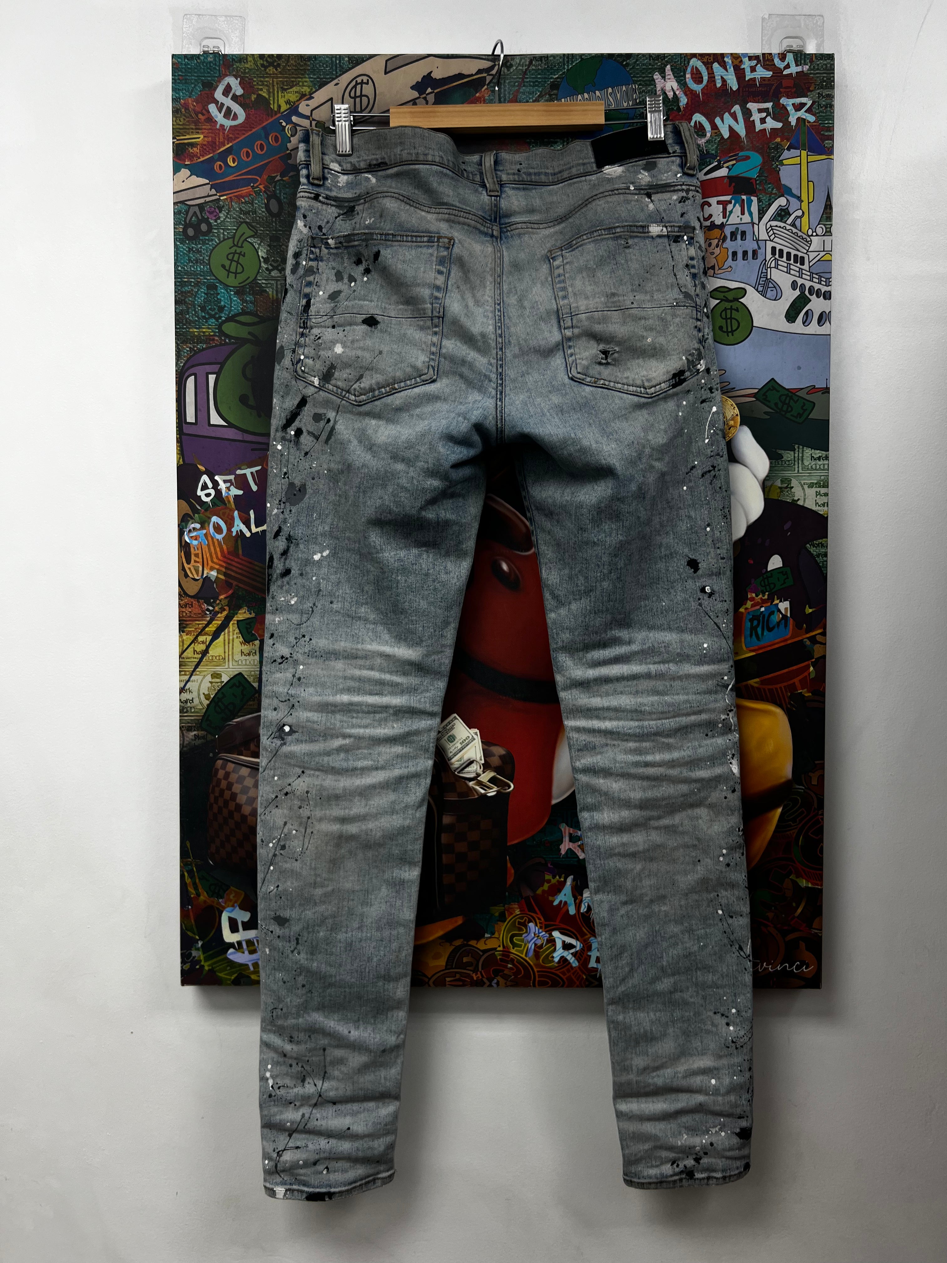 Amiri MX1 Light Wash Denim Paint Splatter Jeans