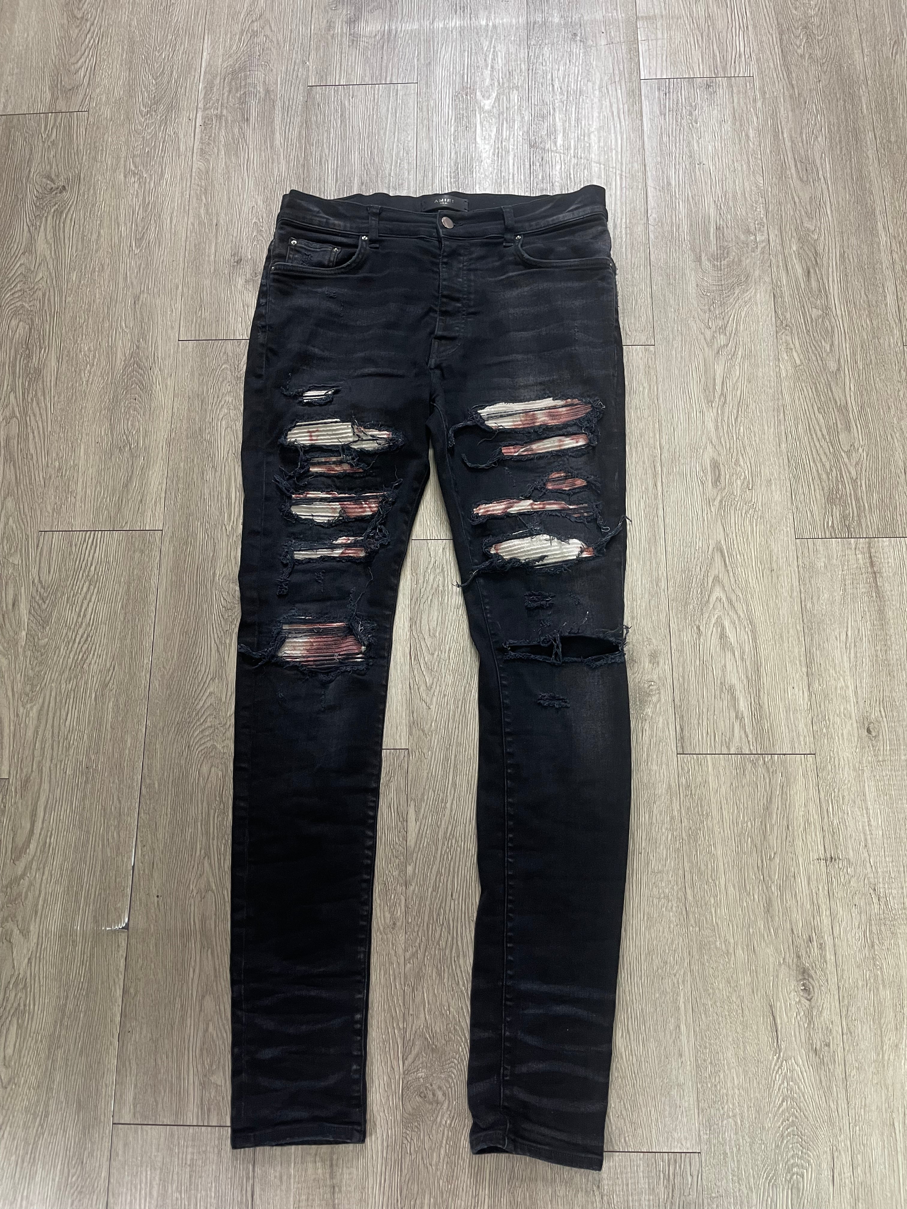 Amiri Black Wash Red White Thrasher Patch Jeans