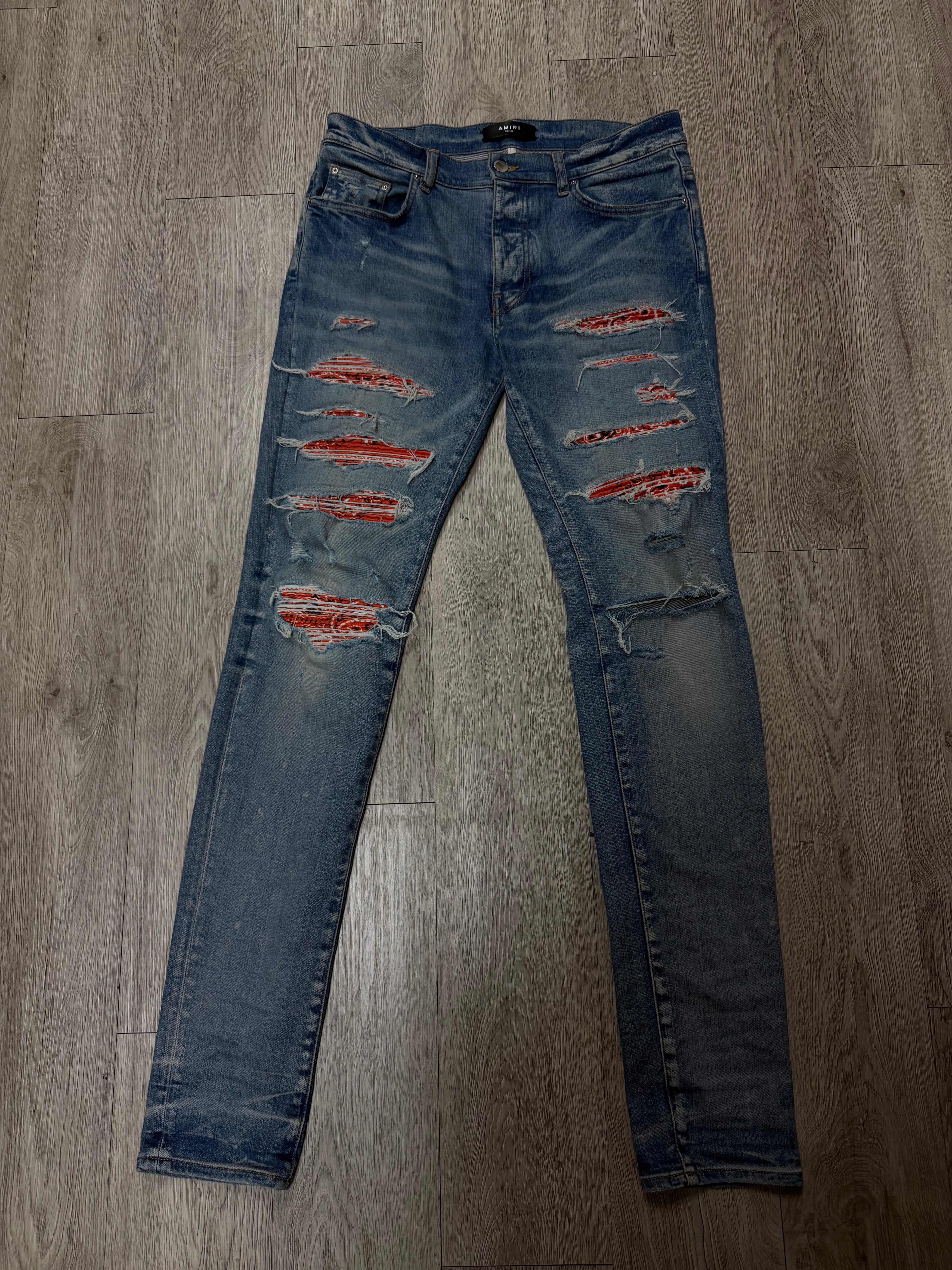 Amiri Light Wash Orange Thrasher Patch Jeans