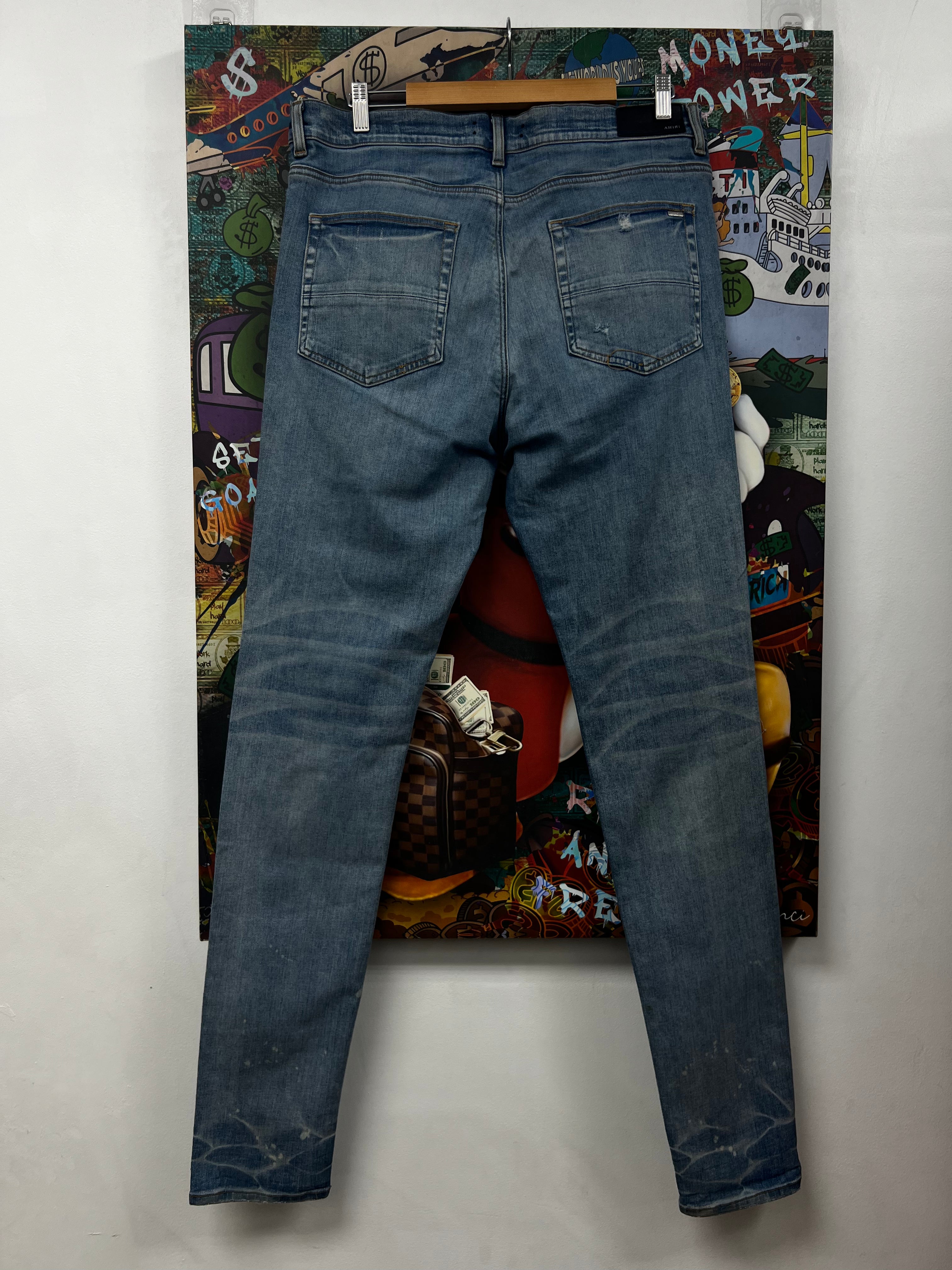 Amiri MX1 Light Wash Black Playboy Patch Jeans