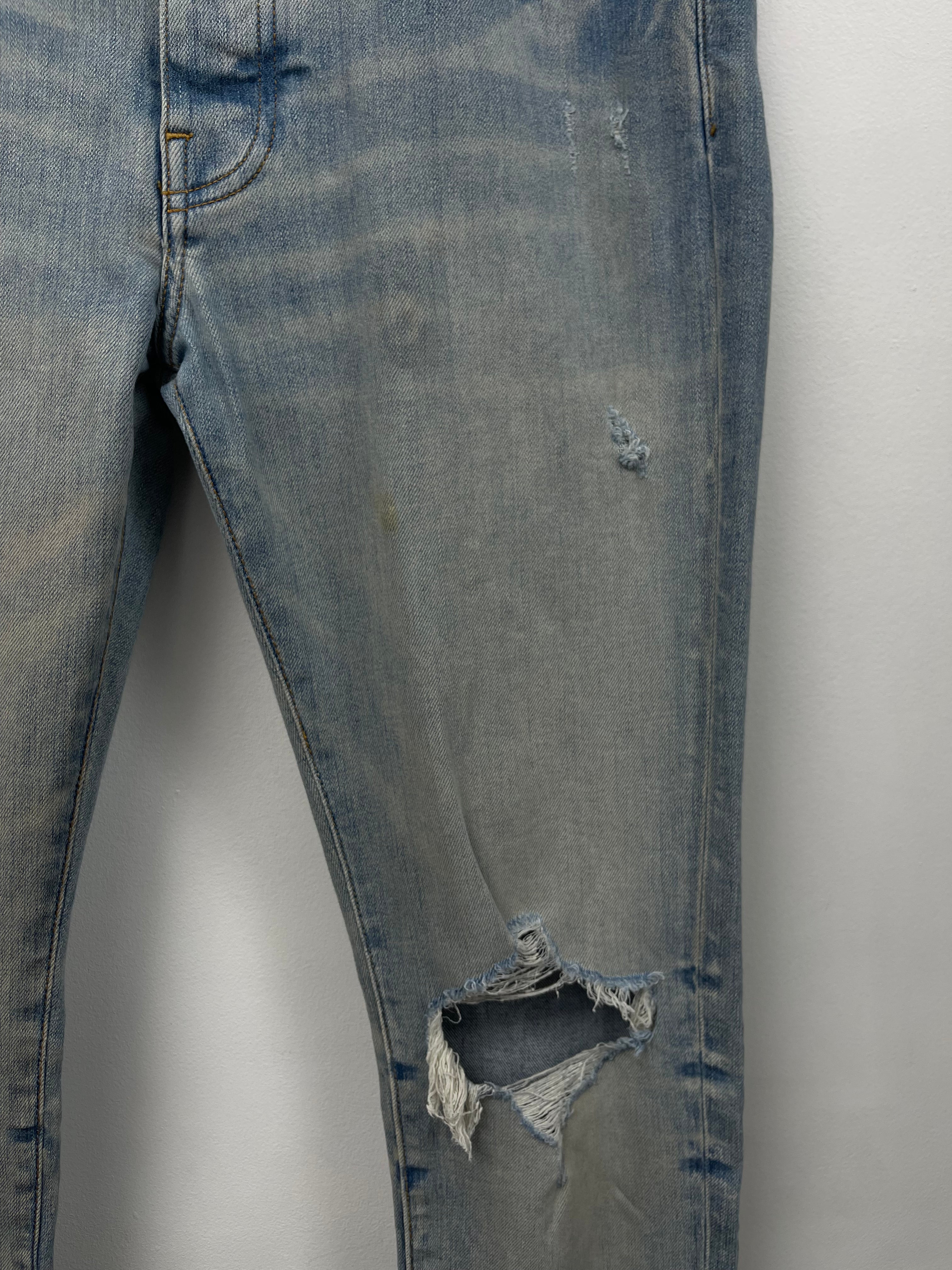 Amiri Light Wash Cherub Ripped (Oil Stain) Jeans