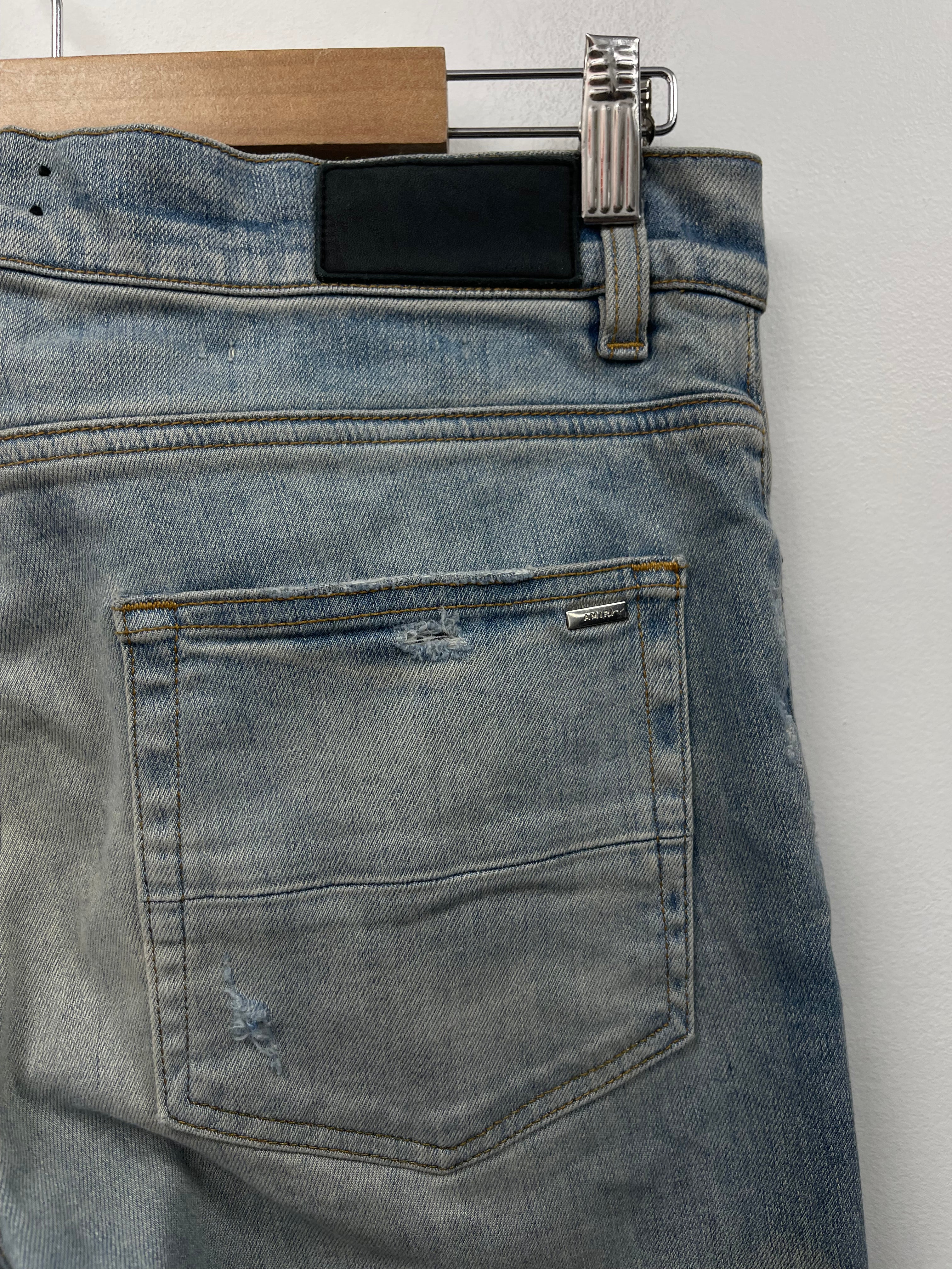 Amiri Light Wash Cherub Ripped (Oil Stain) Jeans