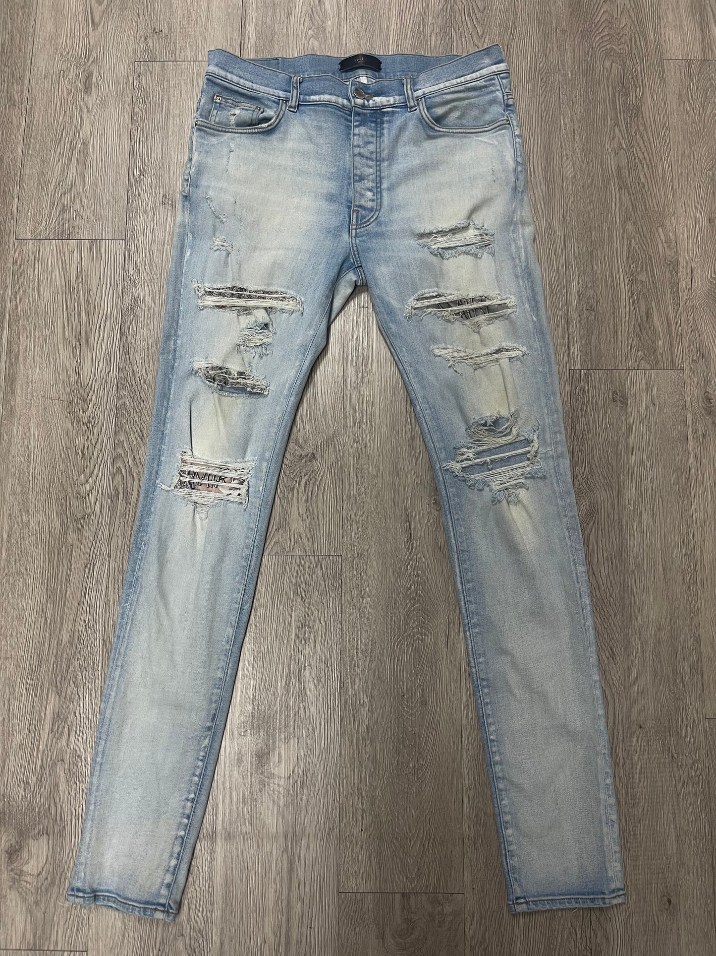 Amiri Light Wash Hibuscus Patch Jeans