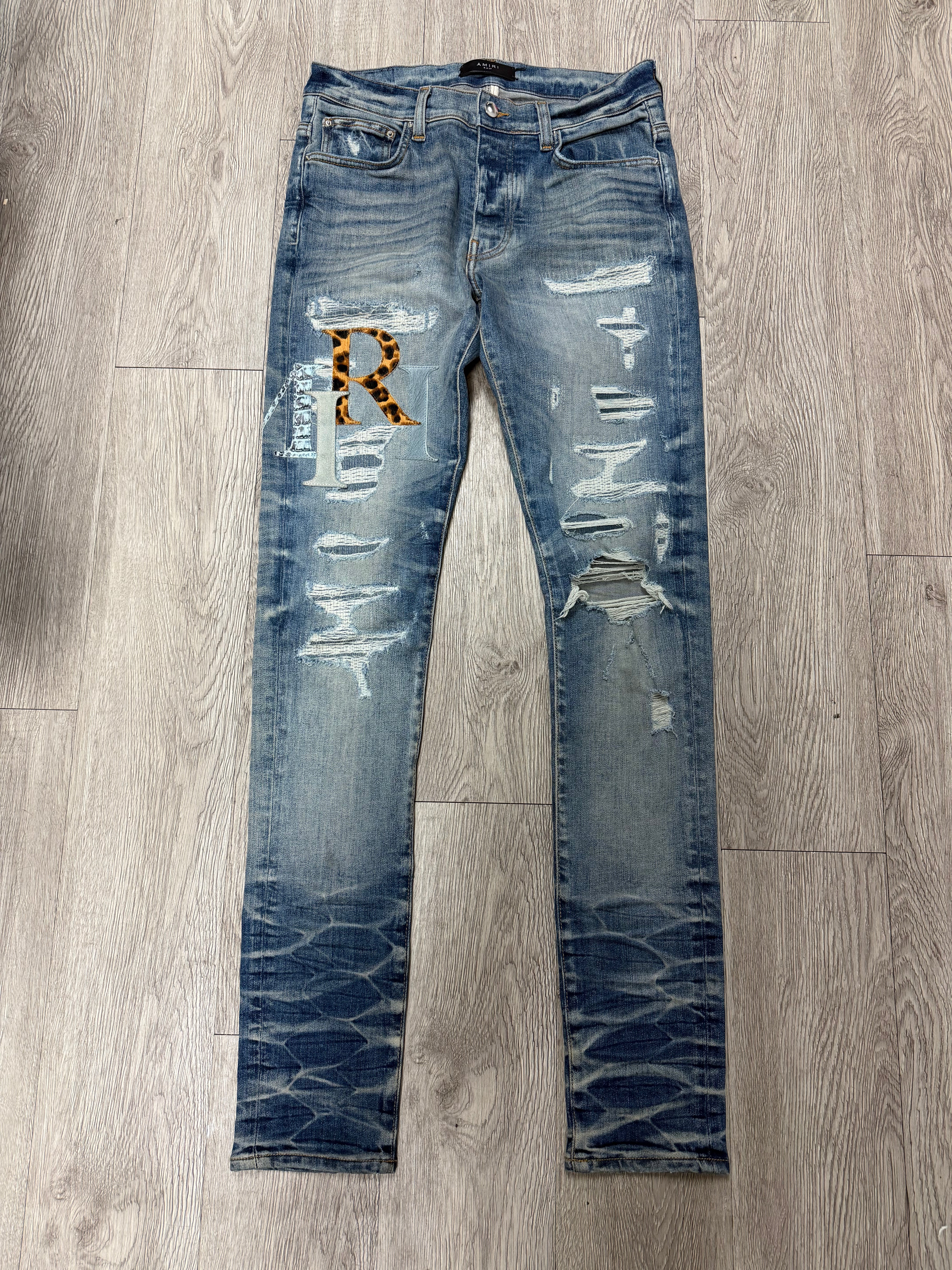Amiri Light Wash Multi Staggered Side Logo Jeans