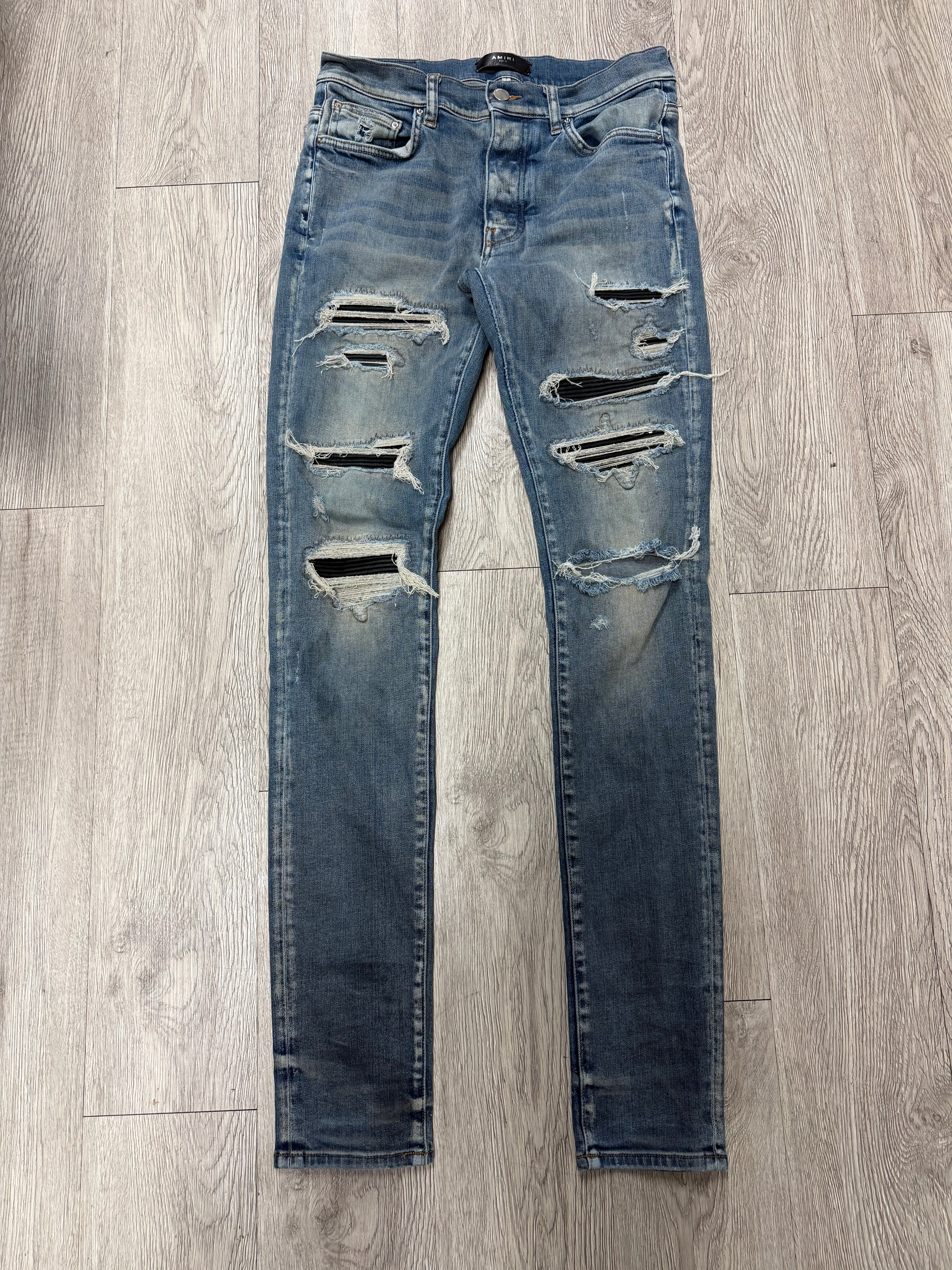 Amiri Light Wash Black Thrasher Patch Jeans
