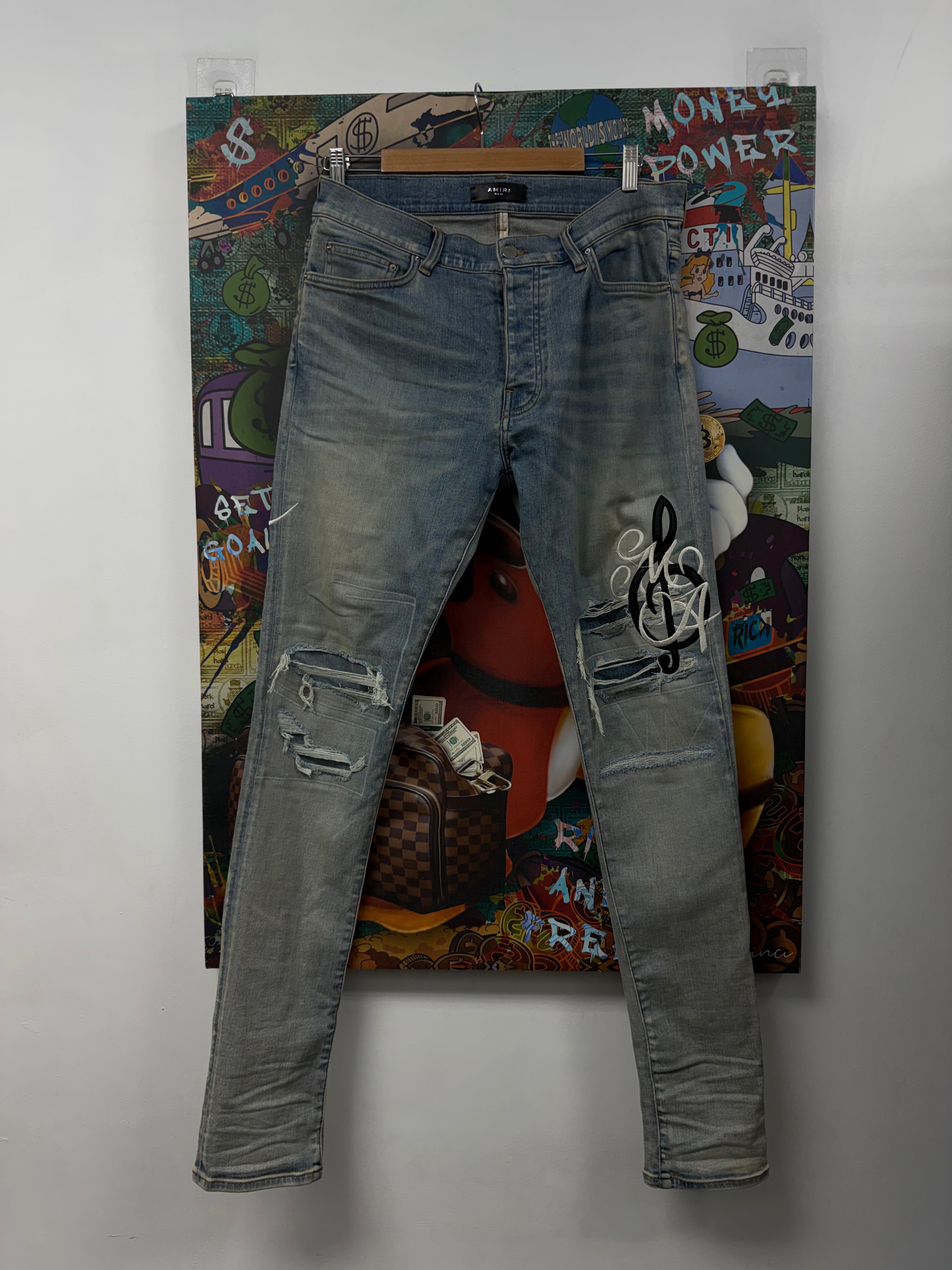 Amiri Light Wash Musical Script Side Logo Jeans
