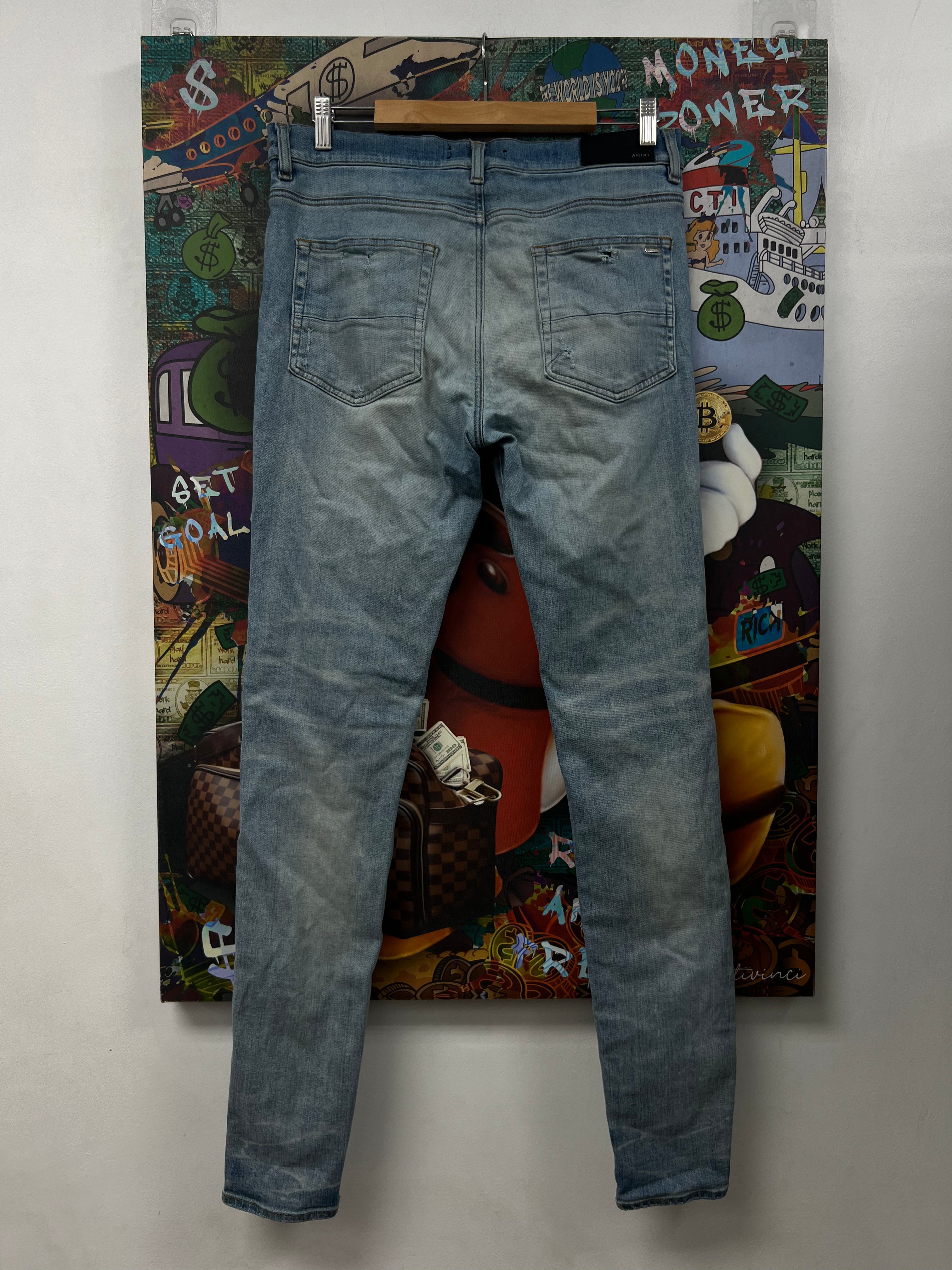 Amiri MX1 Light Wash White Patch Jeans