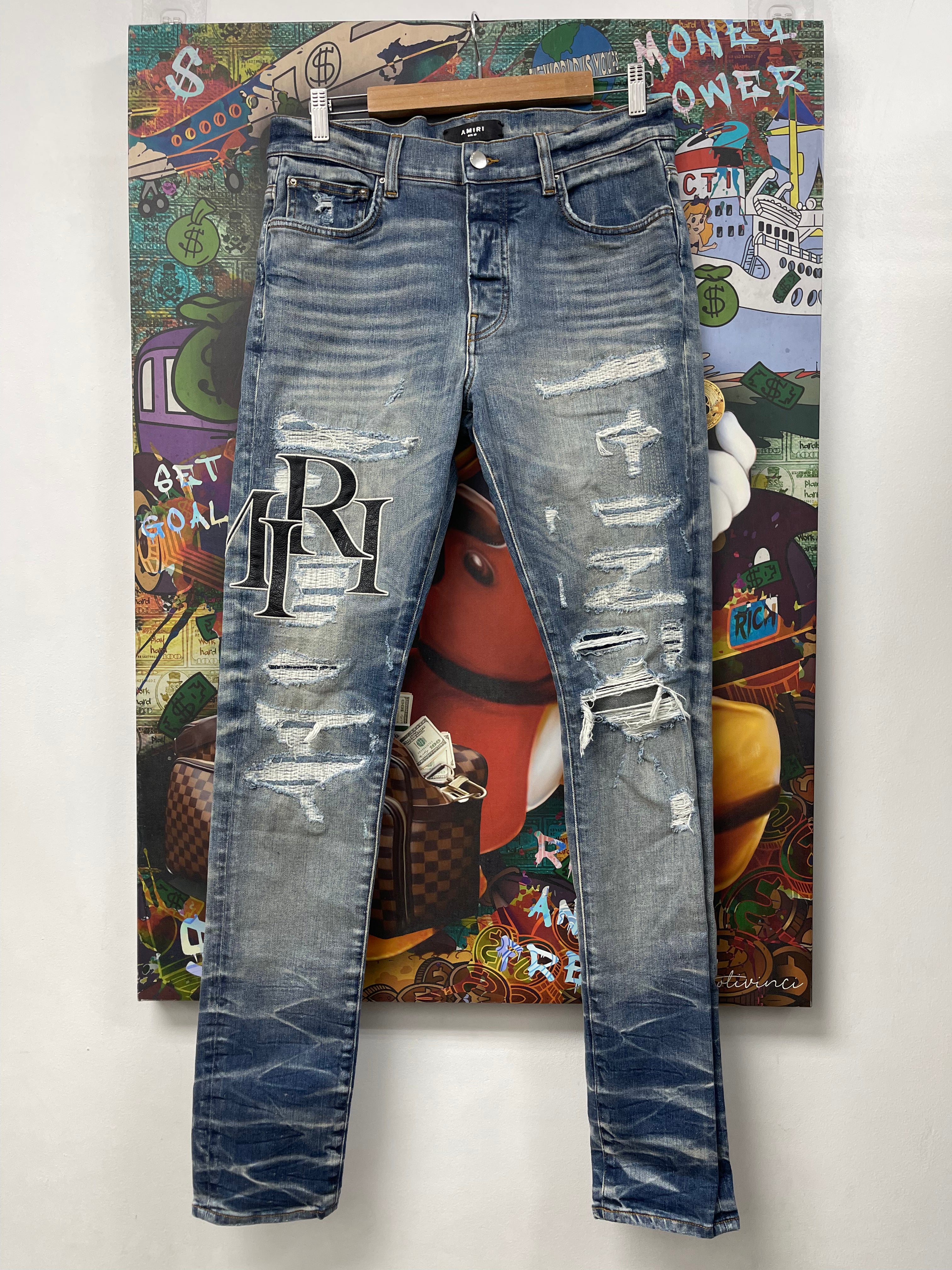 Amiri Light Wash Distressed Staggered Logo Jeans
