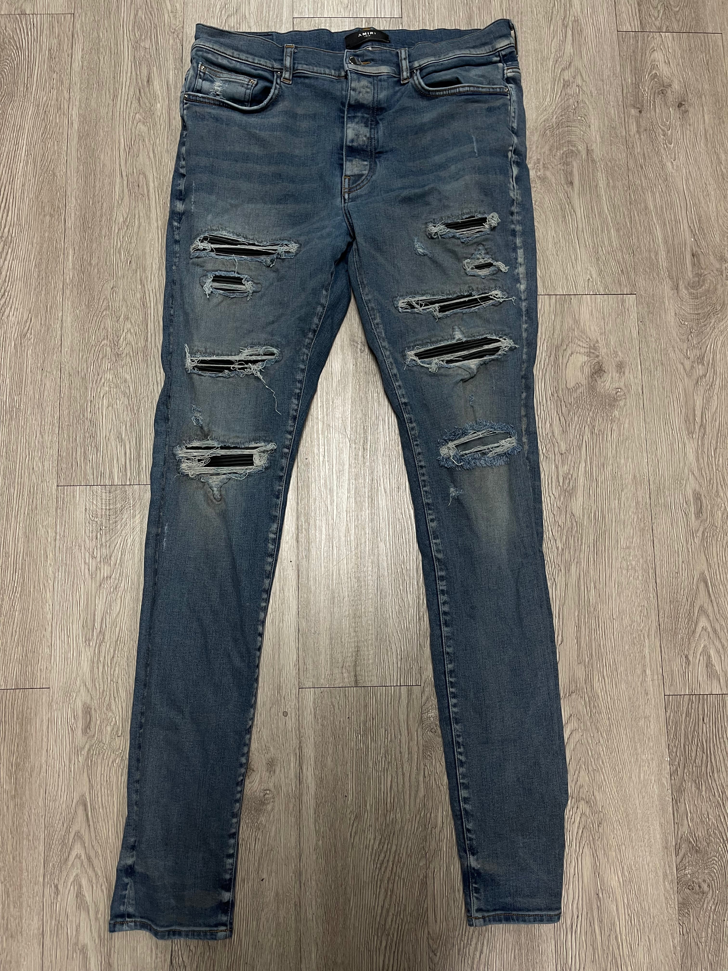 Amiri Light Wash Black Thrasher Patch Jeans
