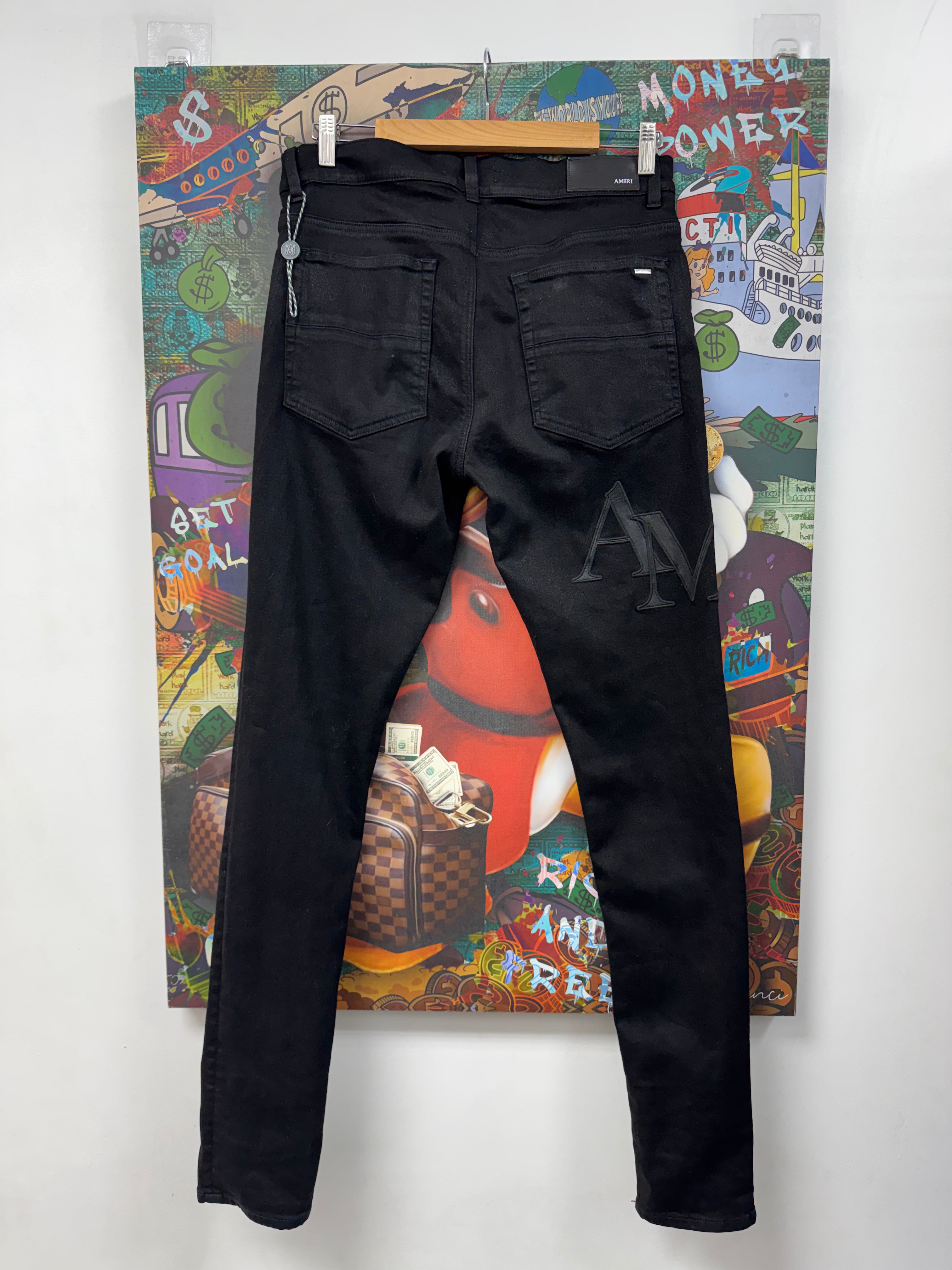 Amiri Black Wax Staggered Side Logo Jeans